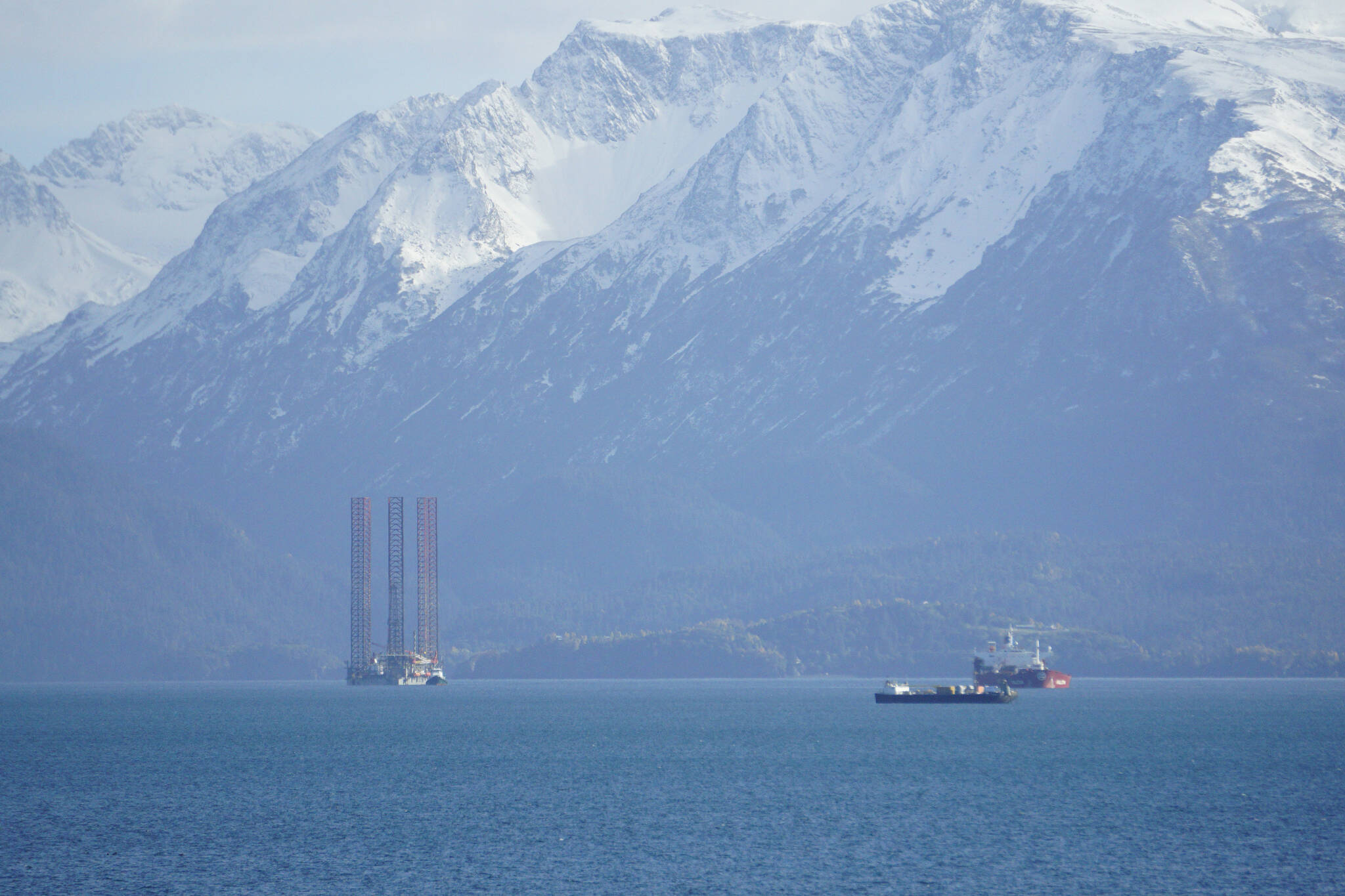 The jack-up rig Randolph Yost, left, awaits loading on the heavy-lift vessel Falcon on Sunday, Oct. 3, 2021, in Kachemak Bay near Homer, Alaska. (Photo by Michael Armstrong/Homer News)