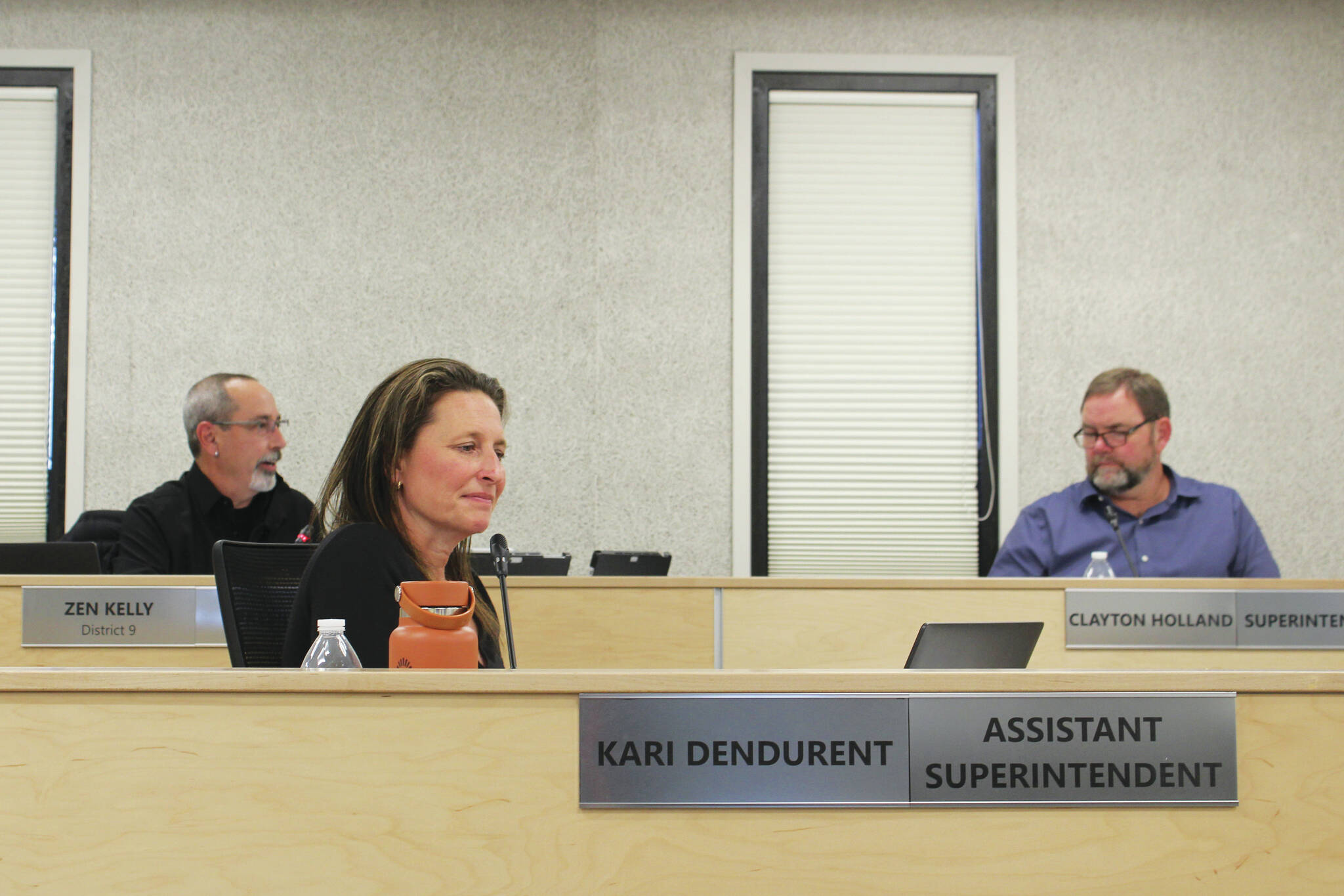 Ashlyn O’Hara / Peninsula Clarion
Kenai Peninsula Borough School District Assistant Superintendent Kari Dendurent (front left) and Superintendent Clayton Holland (back right) listen as Board of Education President Zen Kelly (back left) speaks at a board meeting on Monday in Soldotna.