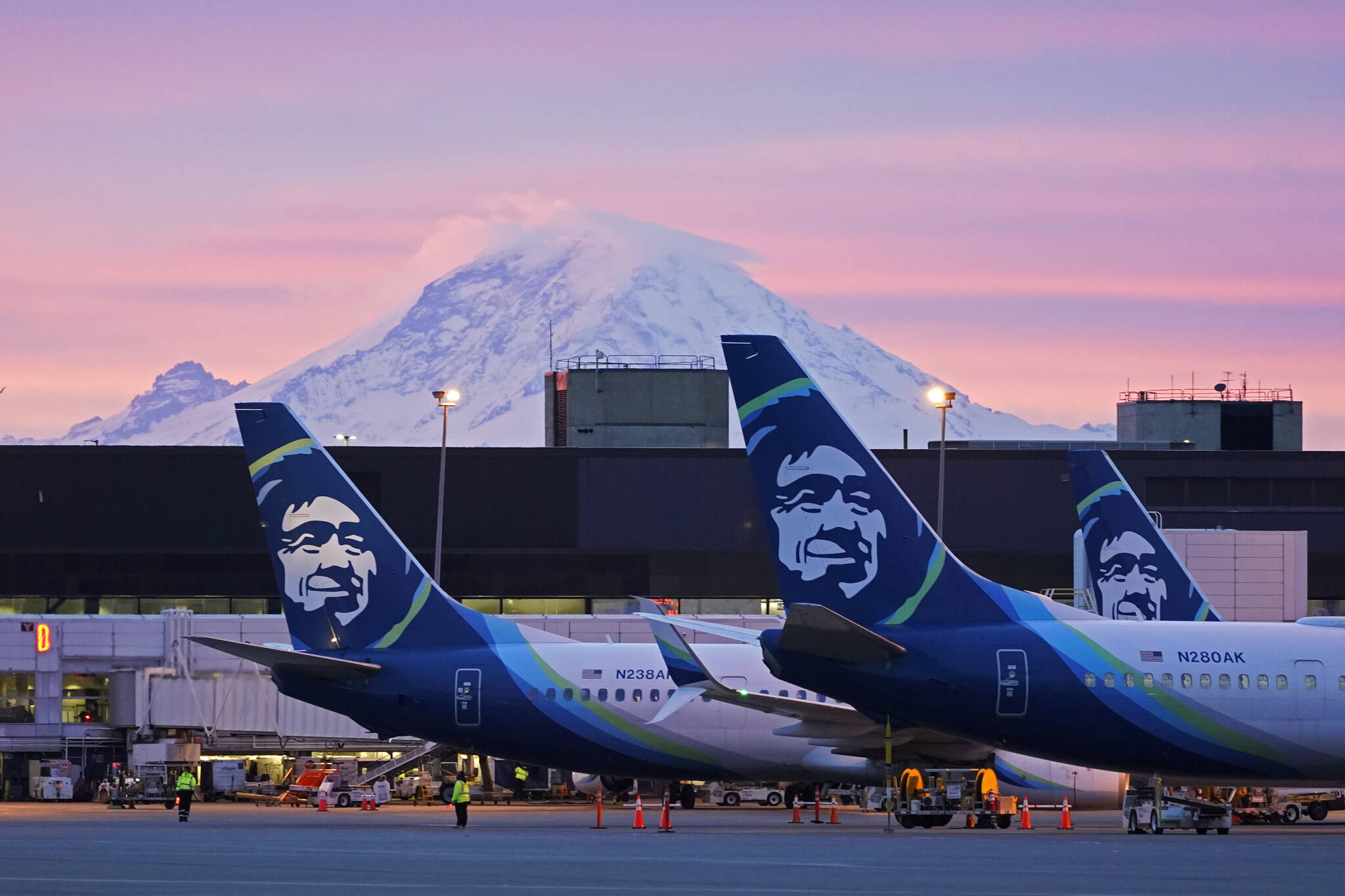 AP Photo / Ted S. Warren 
Alaska Airlines planes are shown parked at gates with Mount Rainier in the background at sunrise, at Seattle-Tacoma International Airport in Seattle. Alaska Air Group has told its 22,000 employees they will be required to get a COVID-19 vaccination. There are some exceptions to the policy, which has shifted since last month, the The Seattle Times reported. In an email Thursday evening to all Alaska Airlines and Horizon Air employees, the Seattle-based company said employees will now be required to be fully vaccinated or approved for a reasonable accommodation.