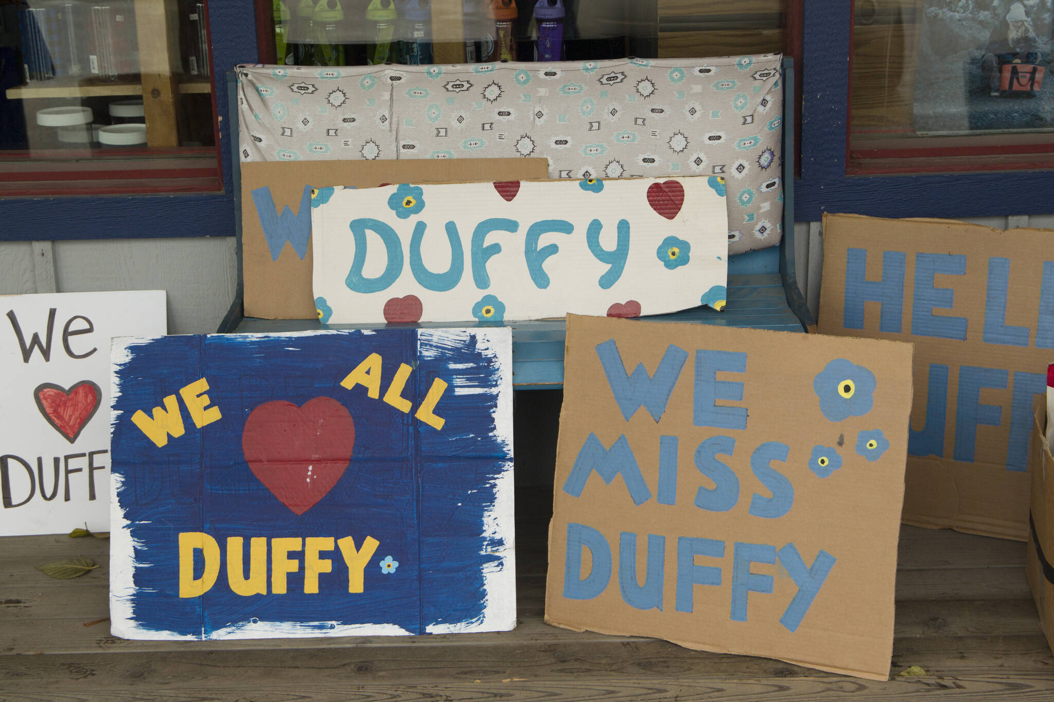 Signs in honor of Duffy Murnane were available for people to hold while retracing her last known steps during the memorial walk on Saturday, Oct. 17. (Photo by Sarah Knapp/Homer News)