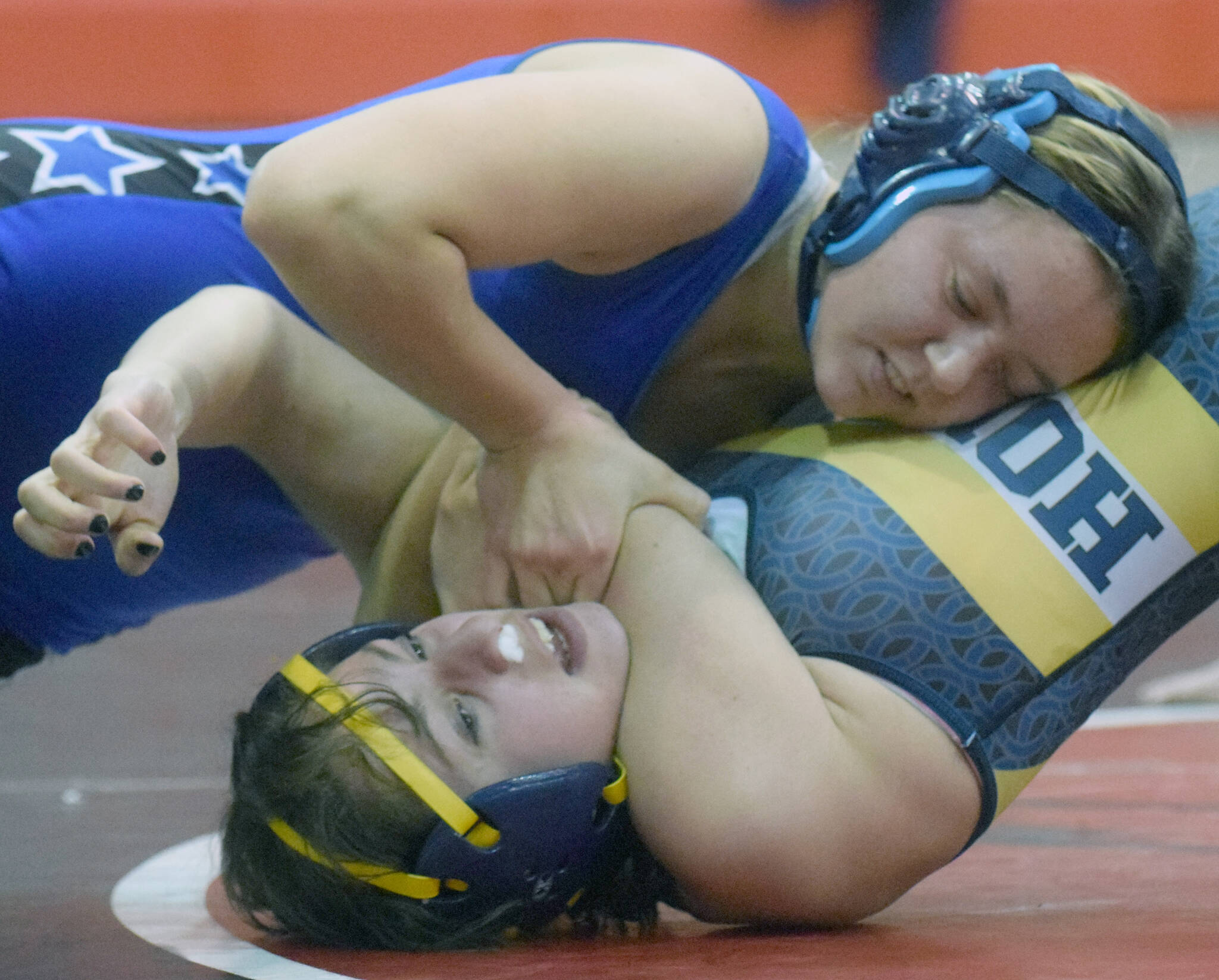 Soldotna’s Daisy Hannevold works her way to a pin of Homer’s Rainey Sundheim at the Luke Spruill Memorial Tournament on Saturday, Oct. 23, 2021, at Kenai Central High School in Kenai, Alaska. Hannevold was second at 145 for the girls, while Sundheim was sixth. (Photo by Jeff Helminiak/Peninsula Clarion)