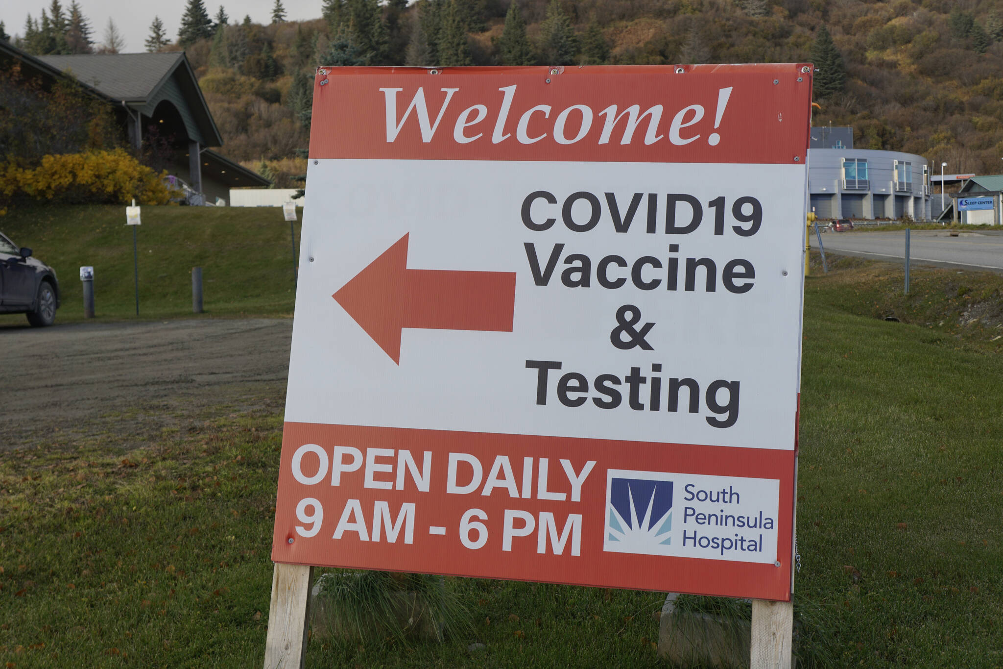 A sign points to the South Peninsula Hospital COVID-19 testing and vaccination clinic on Bartlett Street on Monday, Oct. 24, 2021, in Homer, Alaska. (Photo by Michael Armstrong/Homer News)