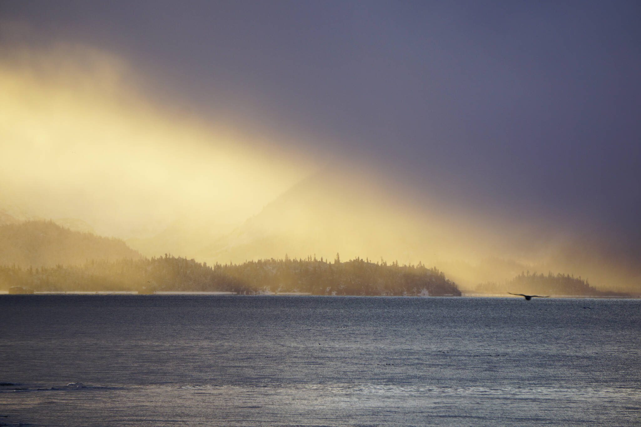 The sun shines on Yukon Island on Thurday, Oct. 28, 2021, as seen from Bishop's Beach in Homer, Alaska. (Photo by Michael Armstrong/Homer News)
