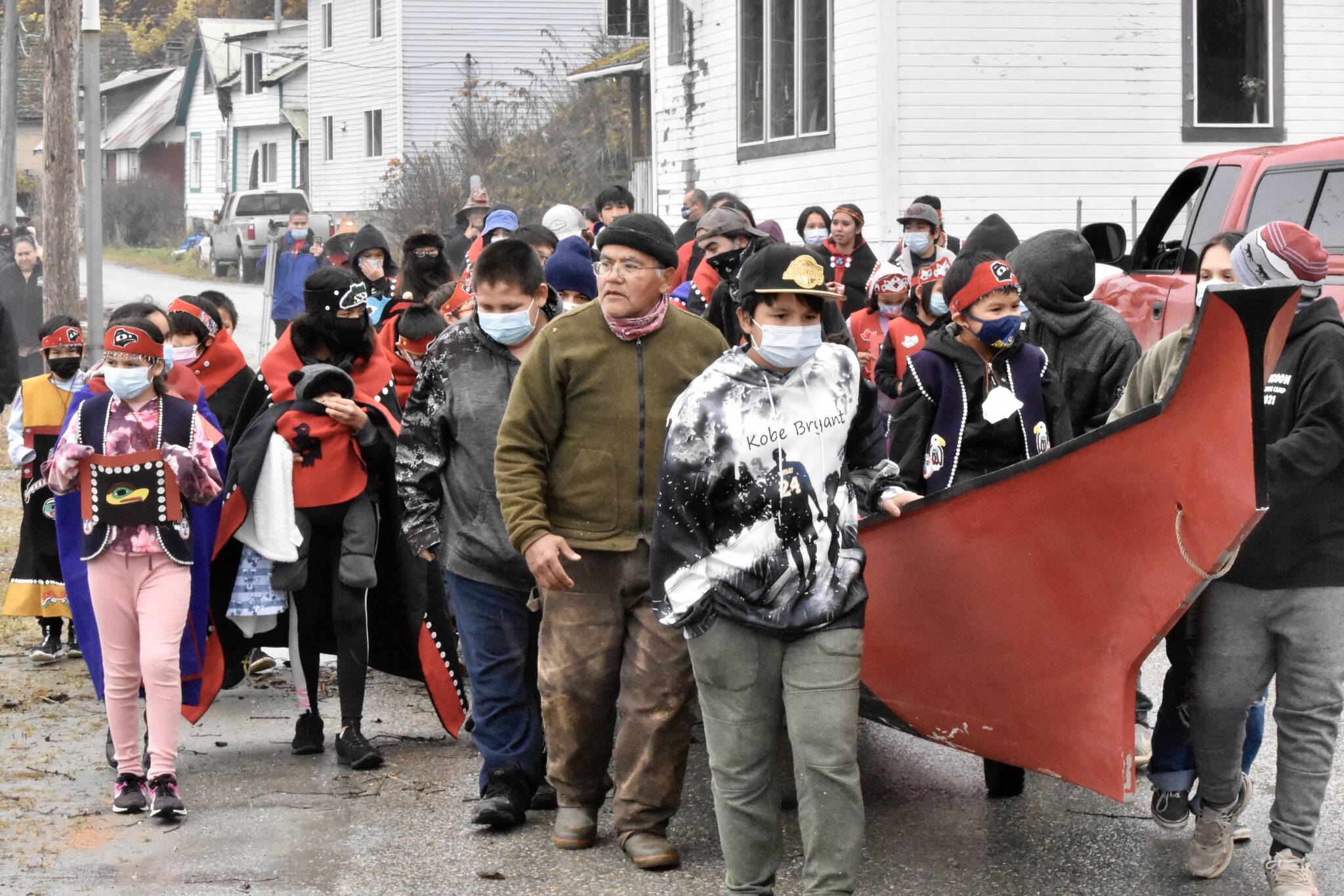 Students in Angoon march down the city’s waterfront on Oct. 26, 2021, to celebrate the anniversary of a bombardment by the U.S. Navy in 1882. Angoon residents chanted and sang as they wheeled the boat along the street just above the beach where similar canoes were destroyed 139 years ago. (Peter Segall / Juneau Empire)
Students in Angoon march down the city’s waterfront on Oct. 26, 2021, to celebrate the anniversary of a bombardment by the U.S. Navy in 1882. Angoon residents chanted and sang as they wheeled the boat along the street just above the beach where similar canoes were destroyed 139 years ago. (Peter Segall / Juneau Empire)