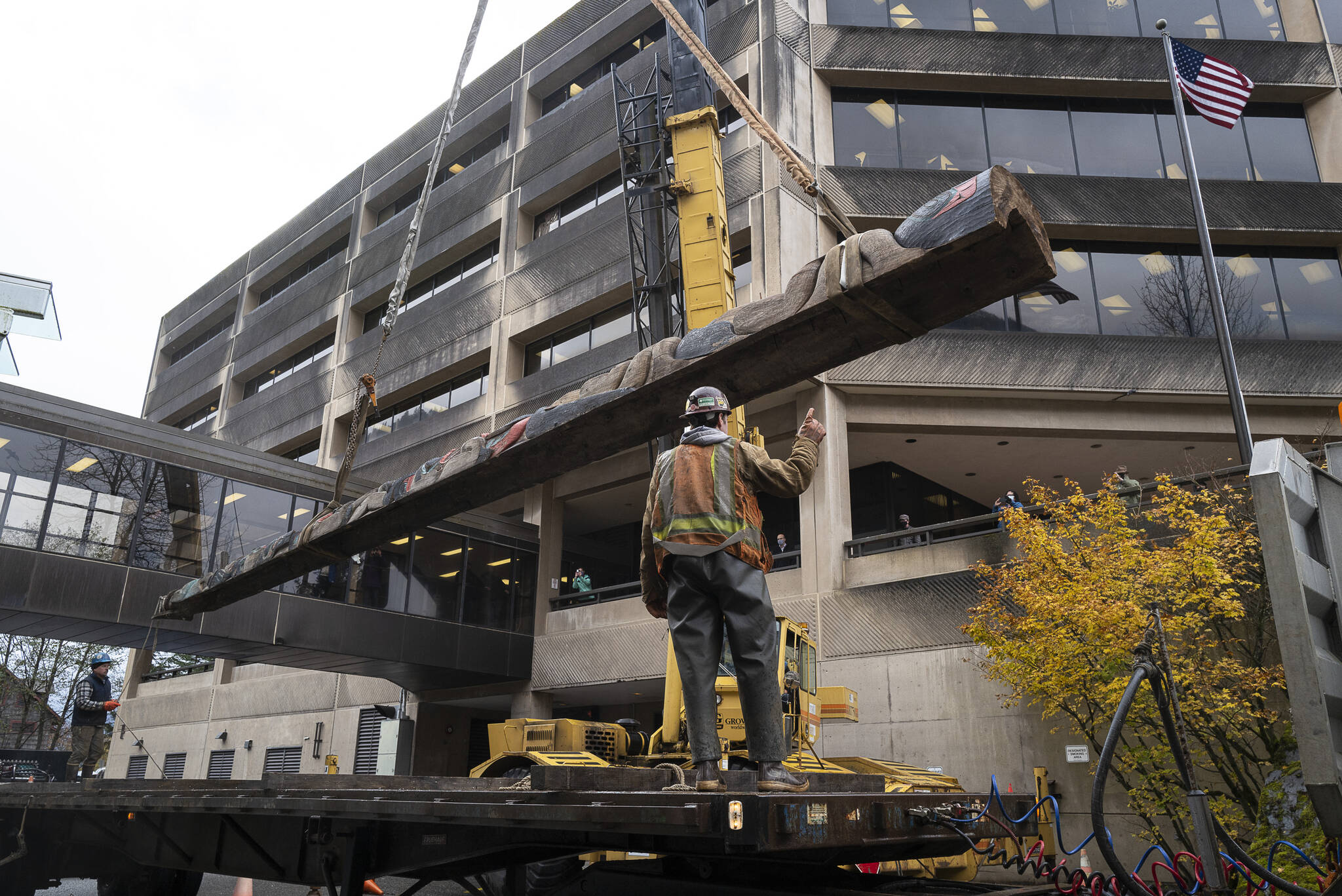It took two forklifts, a large crane, a flatbed truck a team of workers to move the Wooshkeetaan Kootéeyaa (totem pole) to its new location inside the atrium of the State Office Building on Oct. 15. (Michael Penn / For the Jundeau-Douglas City Museum)