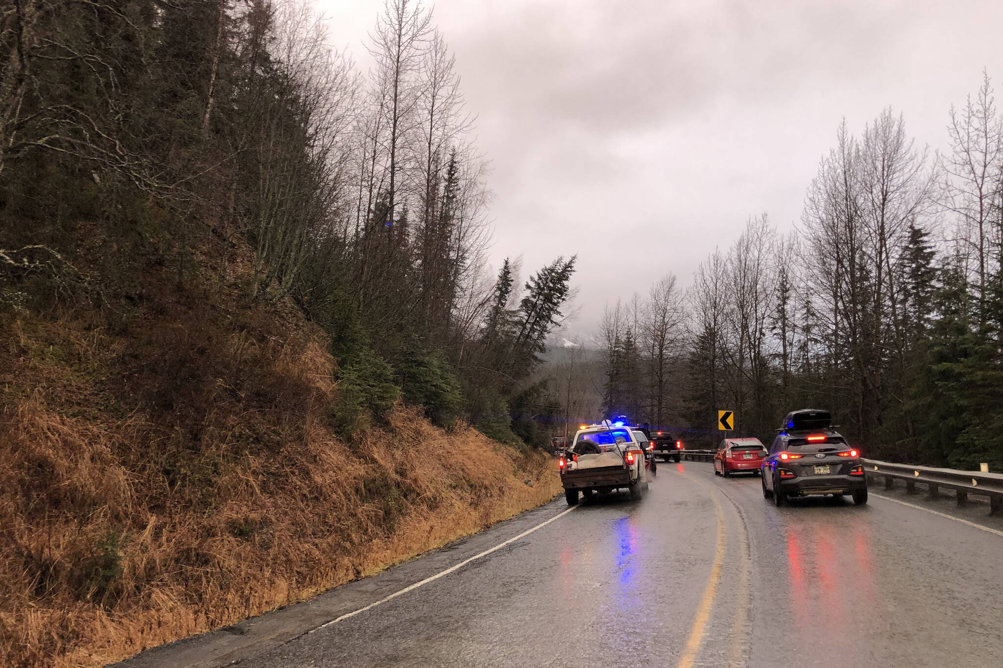 Cars wait while debris is cleared from a section of the Sterling Highway on Monday, Nov. 1, 2021 near Cooper Landing, Alaska. A landslide on Sunday morning blocked both lanes of the highway, which had partially reopened Monday.(Camille Botello/Peninsula Clarion)