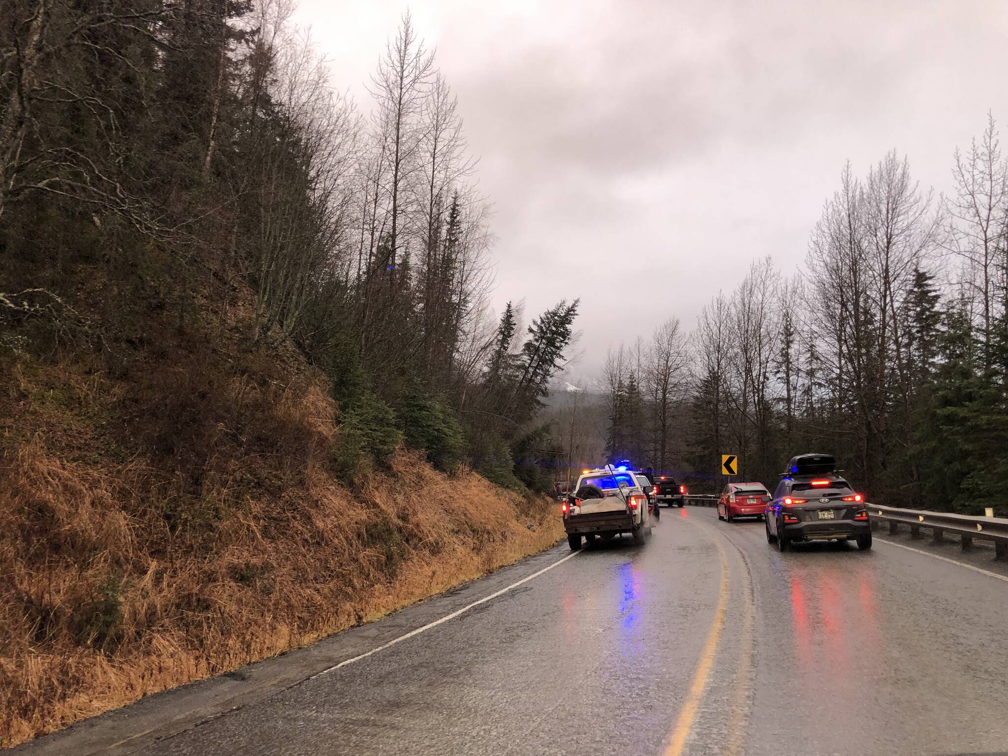 Cars wait while debris is cleared from a section of the Sterling Highway on Monday, Nov. 1, 2021 near Cooper Landing, Alaska. A landslide on Sunday morning blocked both lanes of the highway, which had partially reopened Monday. (Camille Botello/Peninsula Clarion)