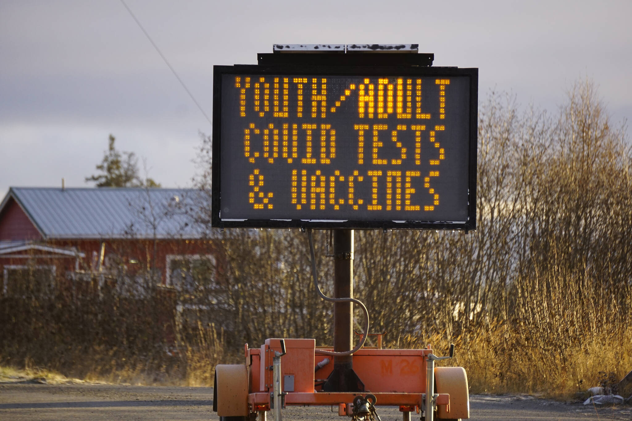 A reader board sign on the Sterling Highway announces COVID-19 testing and vaccines at the South