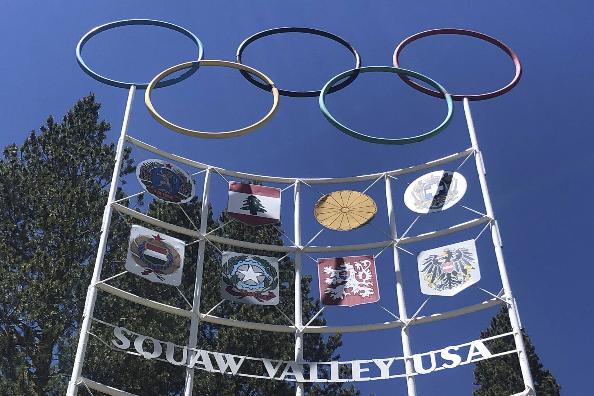 FILE - The Olympic rings stand atop a sign at the entrance to the Squaw Valley Ski Resort in Olympic Valley, Calif., on July 8, 2020. U.S. Interior Secretary Deb Haaland on Friday, Nov. 19, 2021, declared "squaw" to be a derogatory term and said she is taking steps to remove the term from federal government use and to replace other derogatory place names. The popular California ski resort changed its name to Palisades Tahoe earlier this year. (AP Photo/Haven Daley, File)