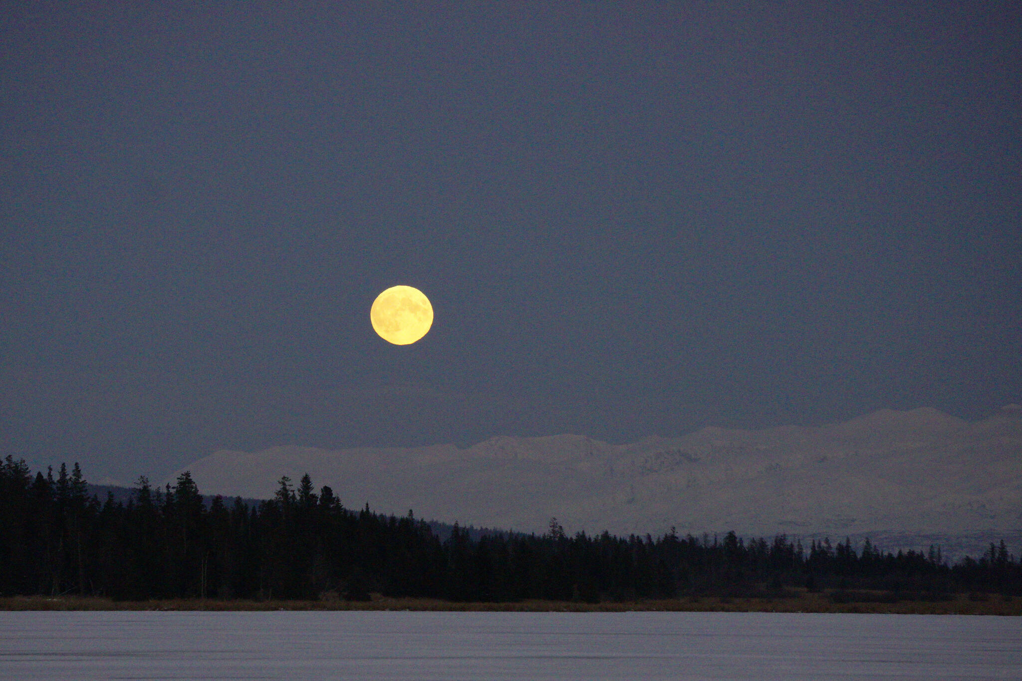 The moon rises over the Kenai Mountains and Beluga Lake at about 5 p.m. Thursday, Nov. 18, 2021, in Homer, Alaska. (Photo by Michael Armstrong/Homer News)