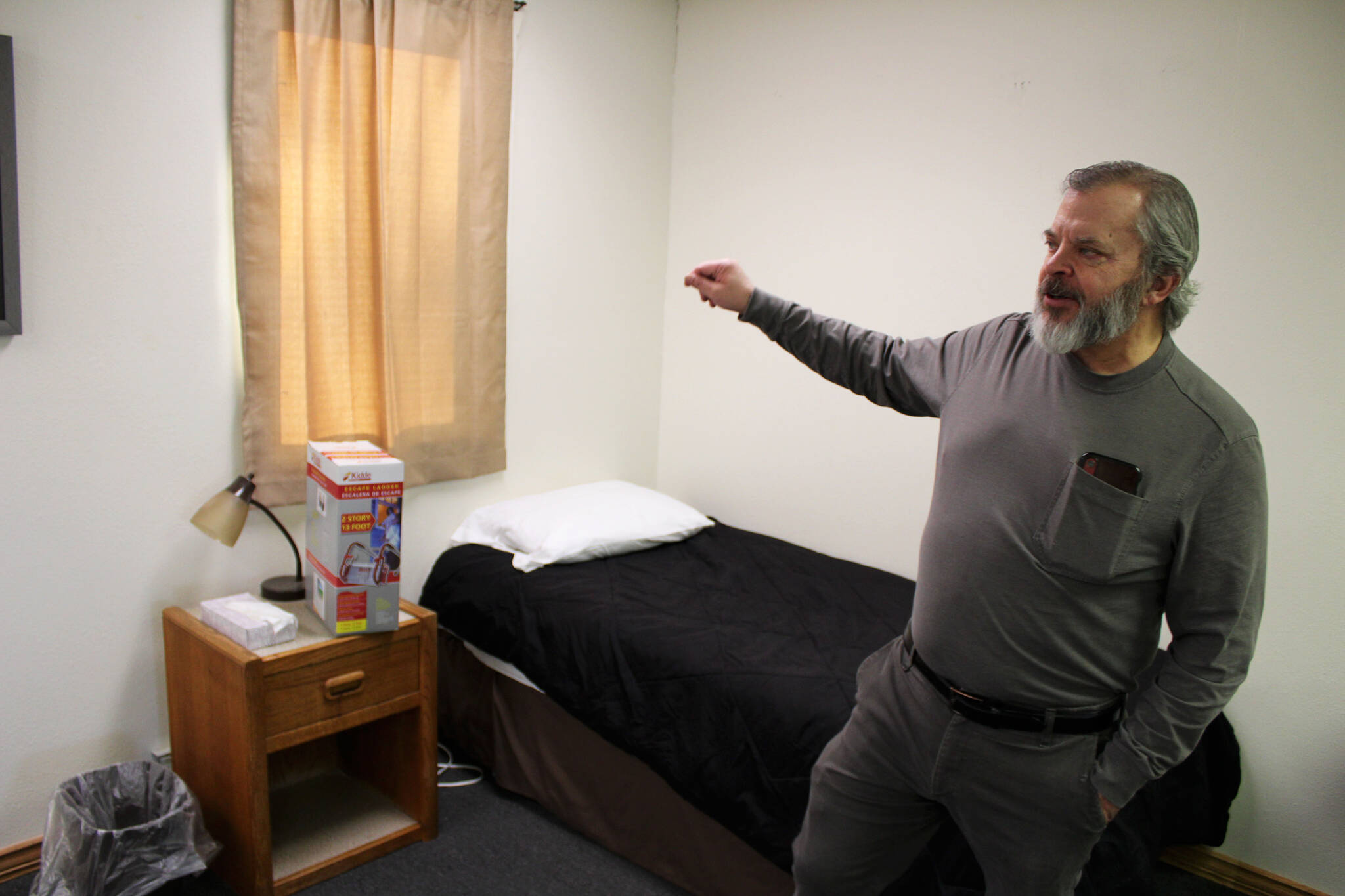 Tim Navarre, president of the Kenai Peninsula Foundation, stands in a bedroom at a cold weather shelter set to open next month on Monday, Nov. 22, 2021 in Nikiski, Alaska. (Ashlyn O’Hara/Peninsula Clarion)