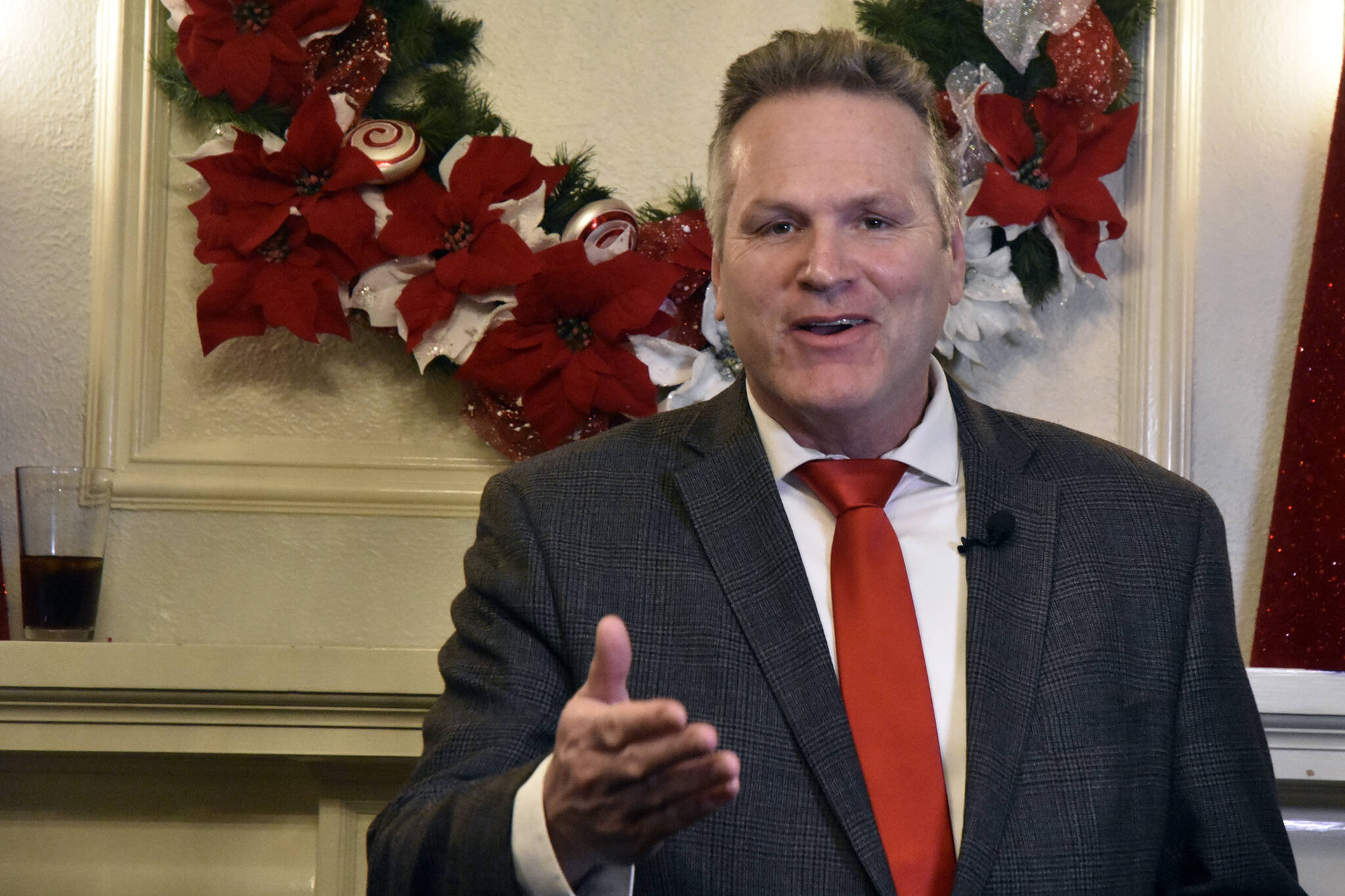 Gov. Mike Dunleavy spoke with reporters at the Alaska Governor's Mansion on Tuesday, Dec. 7, 2021, before greeting guests for the traditional Christmas open house. The event was suspended last year due to COVID-19 but was back this year with limited health mitigation rules in place. (Peter Segall / Juneau Empire)