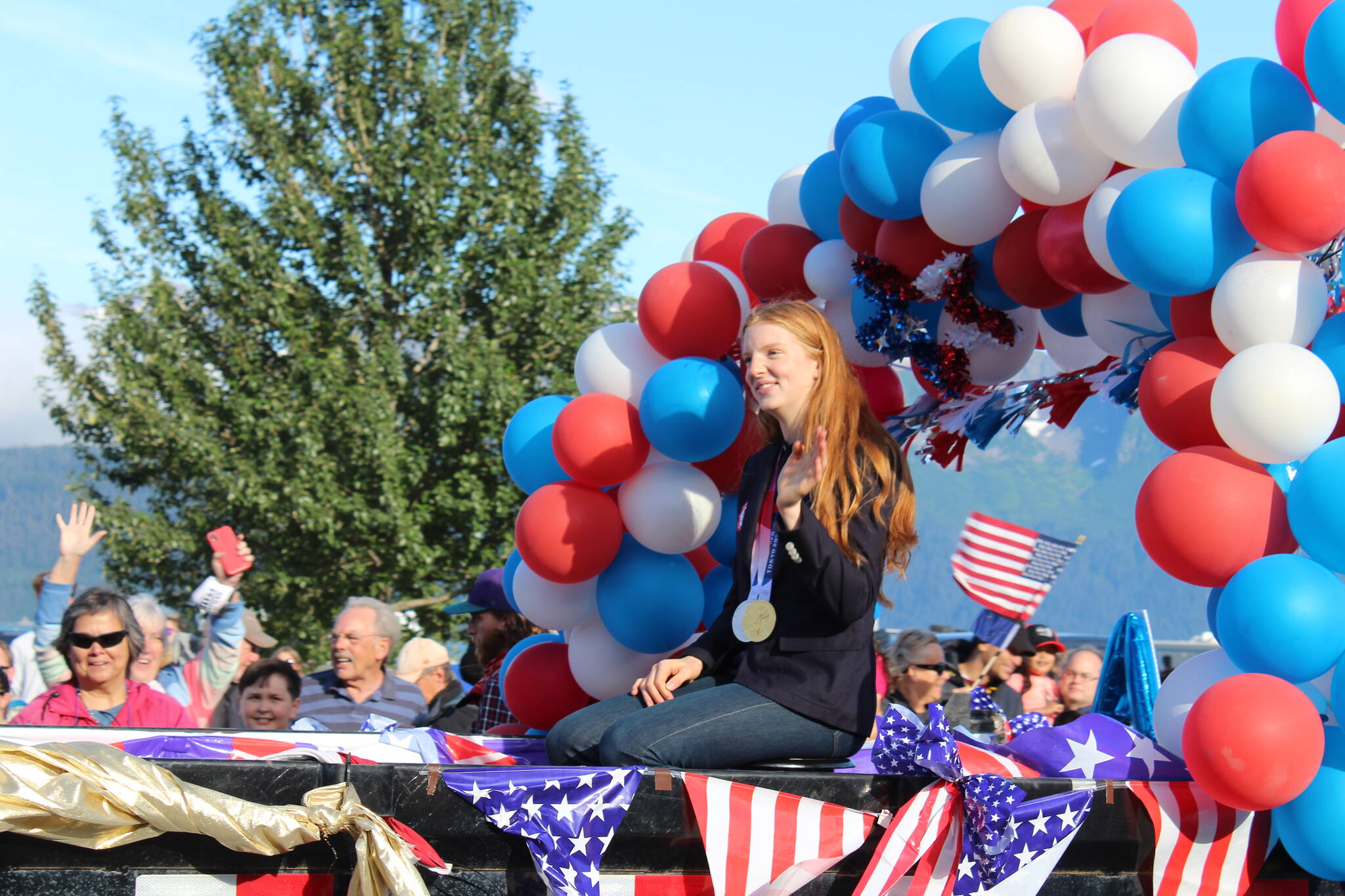 Olympic gold medalist Lydia Jacoby waves to the crowd in Seward during her celebratory parade on Thursday, Aug. 5, 2021. (Ashlyn O’Hara/Peninsula Clarion)