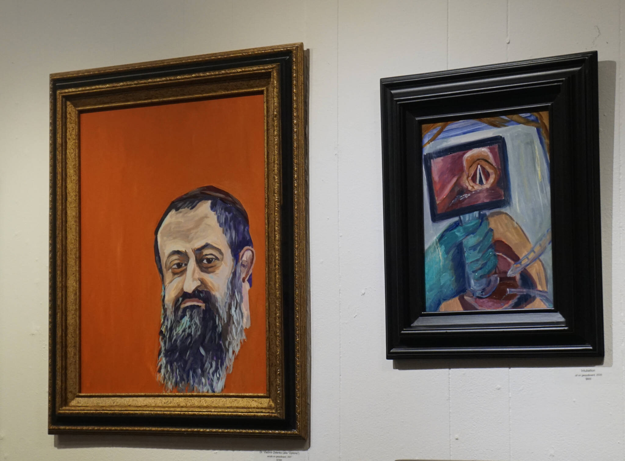 These two paintings are from Dr. Sami Ali’s exhibit, “The Mind of a Healthcare Worker During the COVID-19 Pandemic,” showing in January 2022 at the Homer Council on the Arts in Homer, Alaska. (Photo by Michael Armstrong/Homer News)