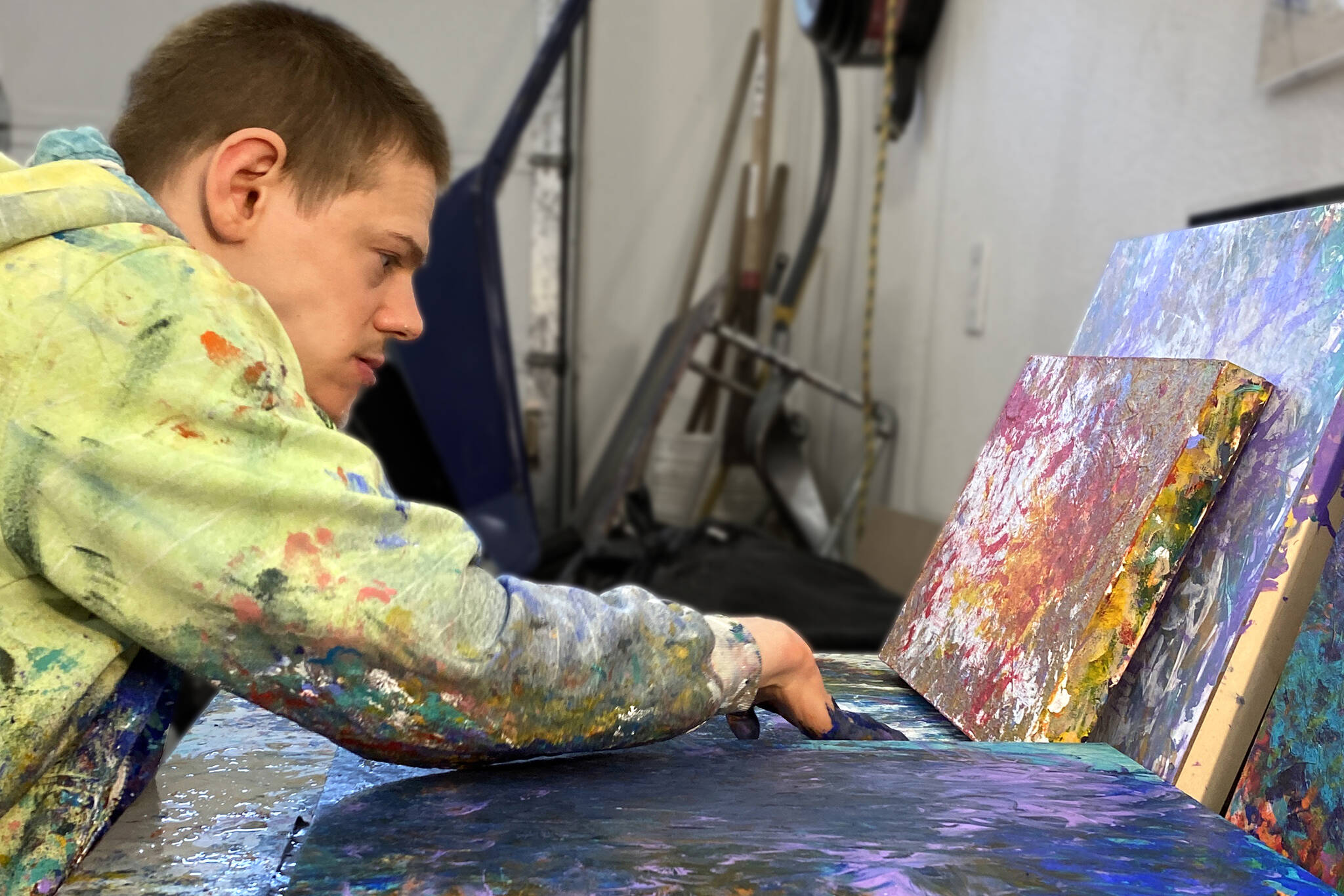 Avery Skaggs works on a painting. Skaggs’ work is featured in a new exhibit at the Juneau-Douglas City Museum. (Courtesy Photo)