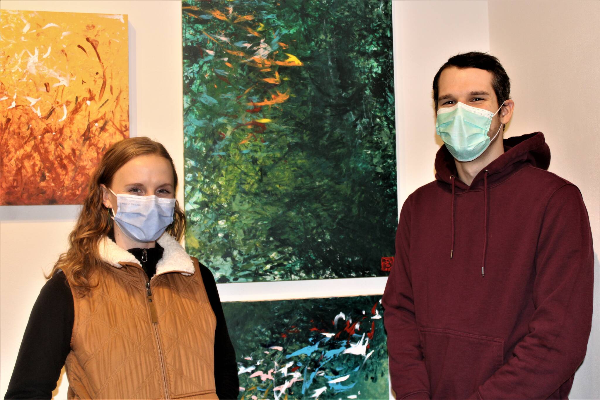 Siblings Lea Skaggs, left, and Drake Skaggs, right, show off work by their brother Avery Skaggs at the opening night of a show at the Juneau-Douglas City Museum featuring a selection of work Avery Skaggs created during the pandemic lockdown. The exhibition is titled “Home: Disability Creativity in a Pandemic Lockdown.” (Dana Zigmund / Juneau Empire)
