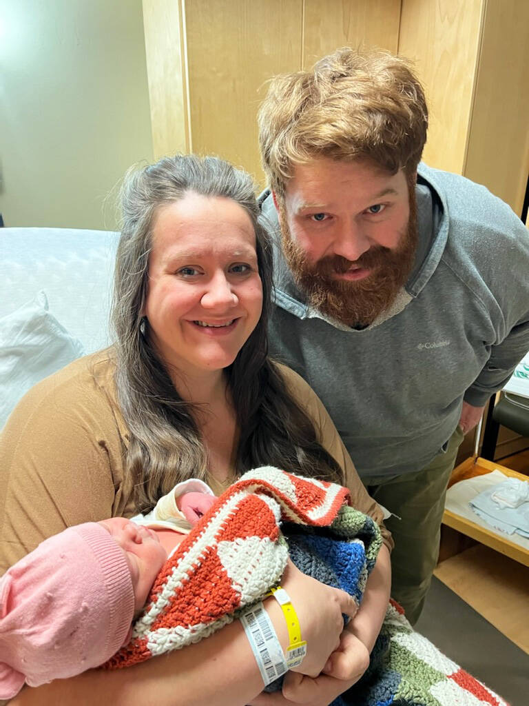 Cassy Quinlan, left, holds her new daughter, Betty Lynn Fraley, while father Jacob Fraley, right, watches on Wednesday, Jan. 19, 2022, at South Peninsula Hospital in Homer, Alaska. Betty Lynn was born on Jan. 17, 2022, the first baby of the New Year. (Photo courtesy of South Peninsula Hospital)