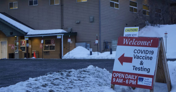 A sign warns of icy conditions in the parking lot of the Bartlett Street COVID-19 vaccine and testing clinic on Thursday, Jan. 13, 2022, in Homer, Alaska. (Photo by Michael Armstrong/Homer News)