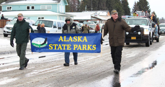 Representatives from the Alaska State Parks march in this year’s Homer Winter Carnival Parade on Saturday, Jan. 8, 2020 on Pioneer Avenue in Homer, Alaska. This year’s theme was a tribute to the 50th anniversary of Kachemak Bay State Park. (Photo by Megan Pacer/Homer News)