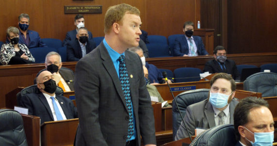 Alaska Republican state Rep. David Eastman, standing, speaks on the House floor on Friday, Feb. 4, 2022, in Juneau Alaska. Alaska House leaders have backed away from a proposal to strip committee assignments from Eastman, who has acknowledged being a member of the far-right organization Oath Keepers, and for now plan to hold at least one hearing on the group. (AP Photo/Becky Bohrer)
