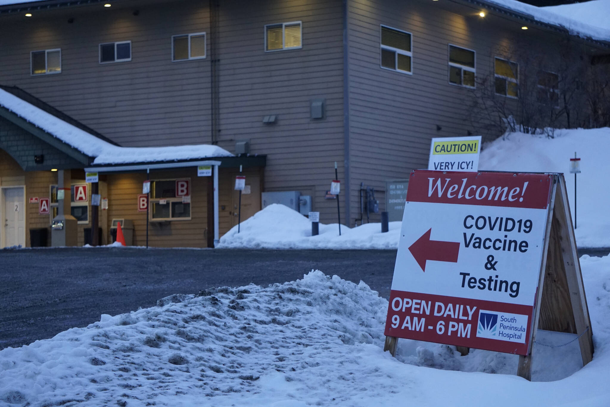 A sign warns of icy conditions in the parking lot of the Bartlett Street COVID-19 vaccine and testing clinic on Thursday, Jan. 13, 2022, in Homer, Alaska. (Photo by Michael Armstrong/Homer News)
