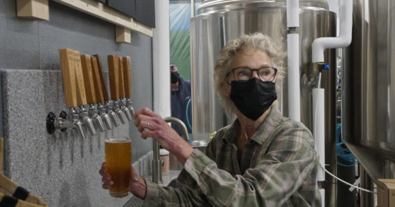 Grace Ridge Brewing co-owner Sherry Stead draws a pint at the brewery’s reopening last Friday, Feb. 11, 2022, at the new location on Smoky Bay Way in Homer, Alaska. (Photo by Michael Armstrong/Homer News)