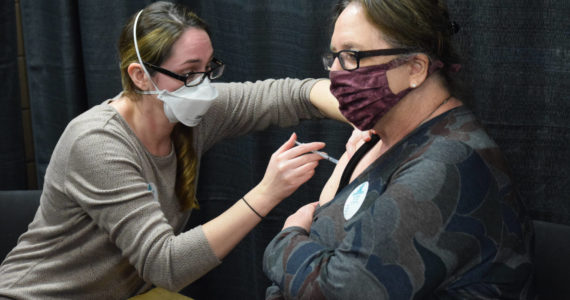 Kenai Public Health Nurse Sherra Pritchard gives Love Inc. Director Leslie Rohr a COVID-19 booster shot during the Project Homeless Connect event in Soldotna on Wednesday, Jan. 26, 2022. (Camille Botello/Peninsula Clarion)