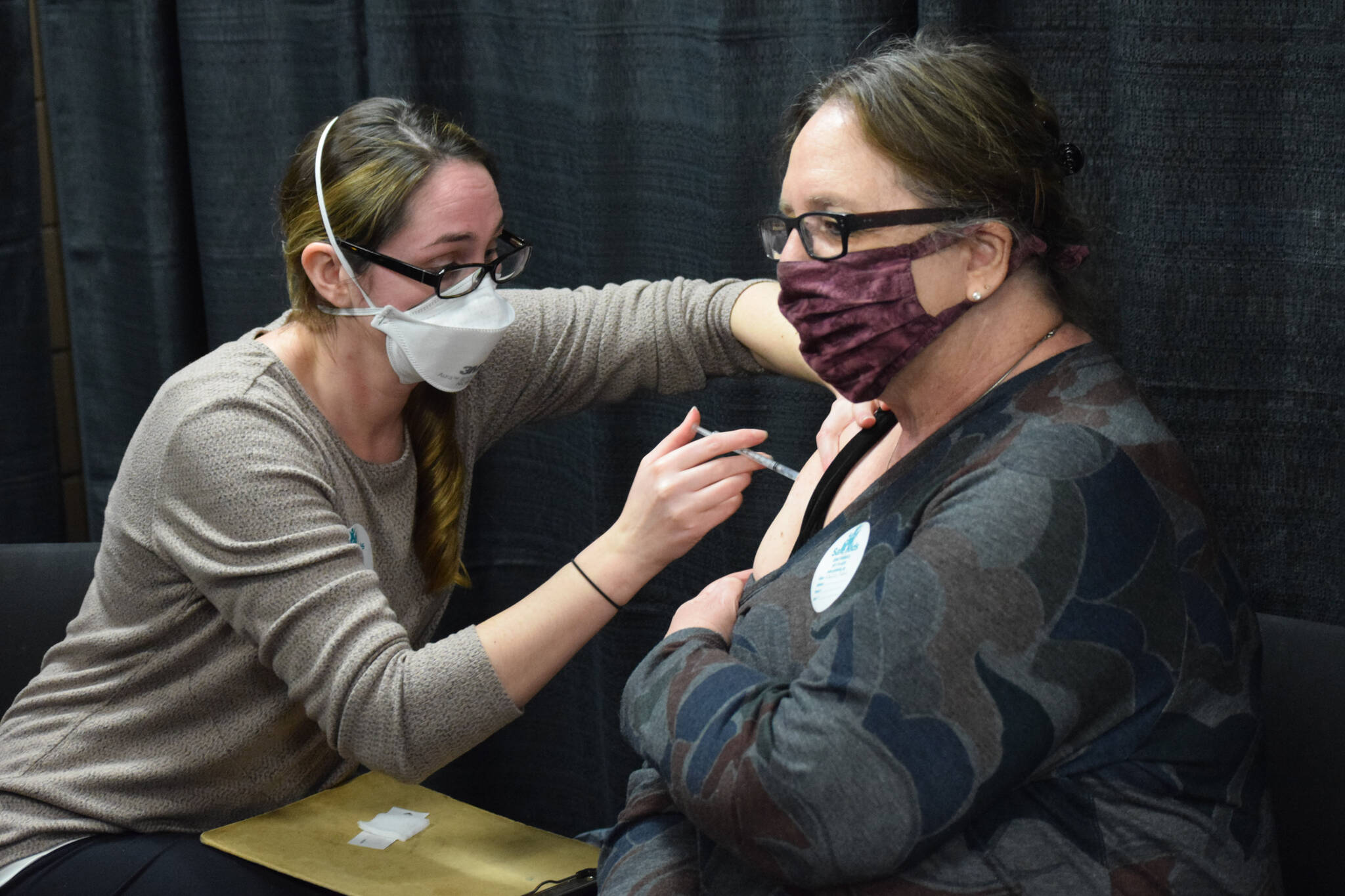 Kenai Public Health Nurse Sherra Pritchard gives Love Inc. Director Leslie Rohr a COVID-19 booster shot during the Project Homeless Connect event in Soldotna on Wednesday, Jan. 26, 2022. (Camille Botello/Peninsula Clarion)