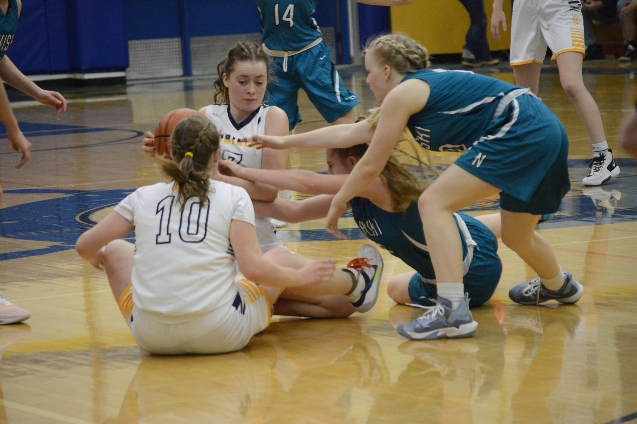 Lady Mariner Kaylin Anderson keeps the ball away from the Lady Bulldogs during Senior Night on Friday, Feb. 25, 2022, at the Alice Witte Gym at Homer High School in Homer, Alaska. (Photo by Michael Armstrong/Homer News)