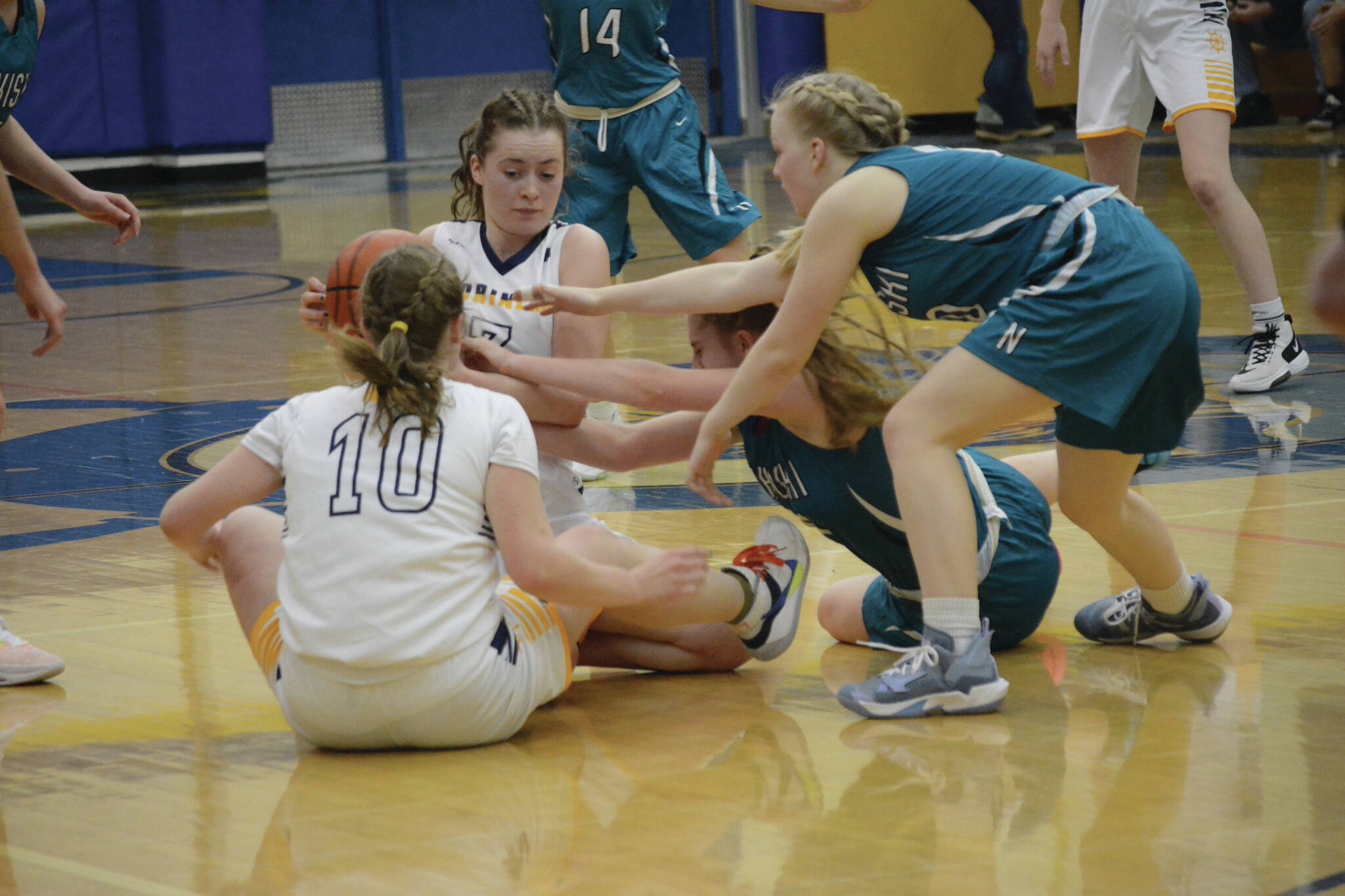 Lady Mariner Kaylin Anderson keeps the ball away from the Lady Bulldogs during Senior Night on Friday, Feb. 25, 2022, at the Alice Witte Gym at Homer High School in Homer, Alaska. (Photo by Michael Armstrong/Homer News)