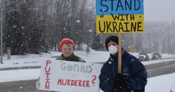 Peggy Mullen and Brent Johnson demonstrate during the Many Voices Ukraine vigil on Saturday, March 5, 2022, in Soldotna, Alaska. (Camille Botello/Peninsula Clarion)