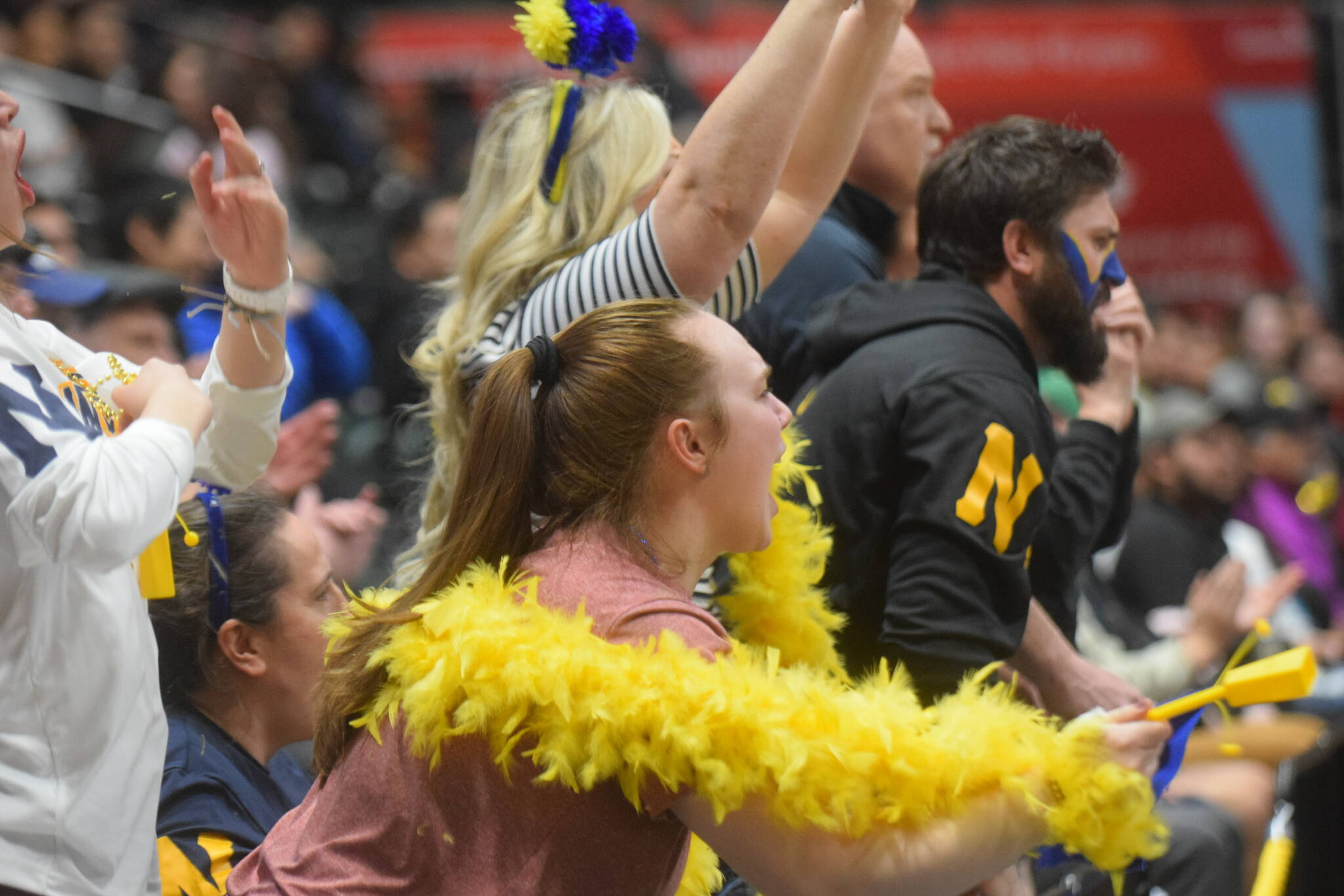 Ninilchik fans cheer on the Wolverines during the Class 2A state basketball championship game at the Alaska Airlines Center in Anchorage, Alaska, on Saturday, March 19, 2022. (Camille Botello/Peninsula Clarion)