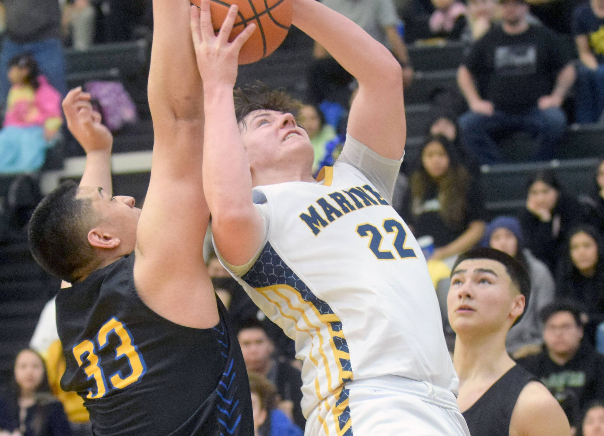 Homer’s Carter Tennison takes a shot against Barrow’s Uata Tuifua during the Class 3A boys basketball fourth-place semifinals at the Alaska Airlines Center in Anchorage, Alaska, on Thursday, March 24, 2022. (Camille Botello/Peninsula Clarion)