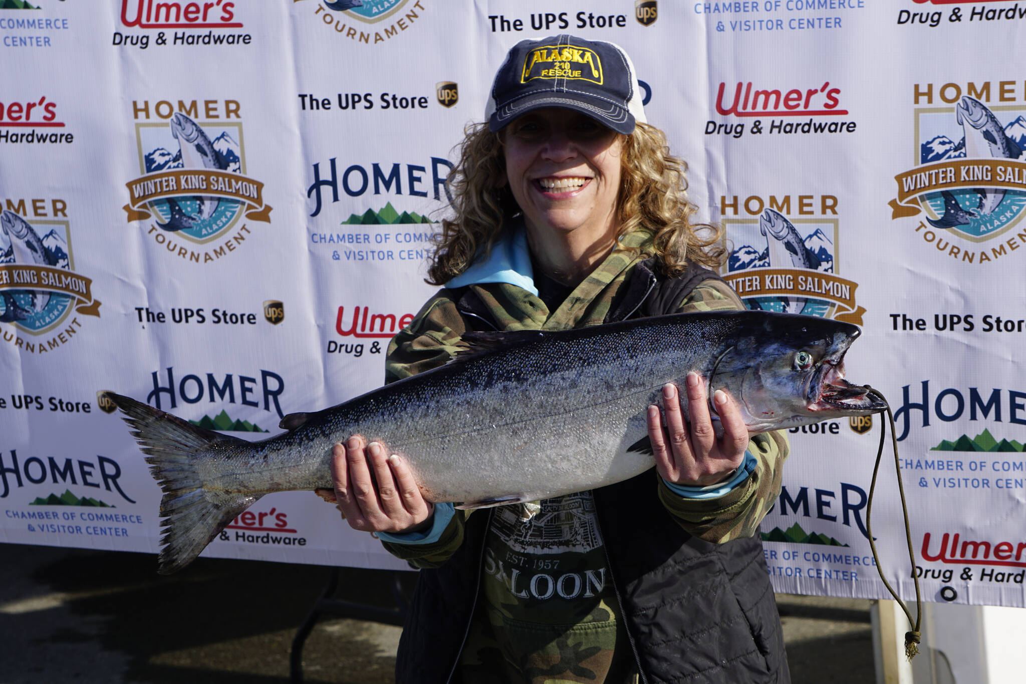 Mary Jo Porter holds the 9.24-pound winter king salmon she caught in the 28th annual Homer Winter King Salmon Tournament on Sunday, April 10, 2022, in Kachemak Bay, Homer, Alaska. (Photo by Michael Armstrong/Homer News)