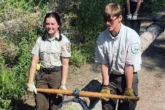 YCC Enrollees harvest beetle-killed spruce for a facility enhancement project. (Photo by Nick Longobardi/FWS)