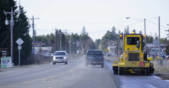 A street sweeper on Tuesday, April 19, 2022, cleans the bike and pedestrian lane on Ocean Drive in Homer, Alaska. Cleaning sand and debris off the side of the road will make Ocean Drive safer for Homer's growing bicycle community. (Photo by Michael Armstrong/Homer News)