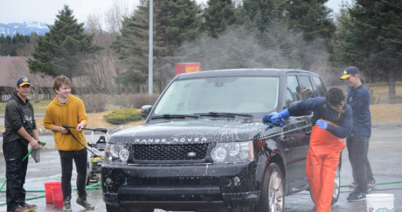 Members of the Homer Mariner baseball team wash cars for a fundraiser on Saturday, April 23, 2022, at Wells Fargo in Homer, Alaska. The Mariners play Friday vs. Redington High School in Wasila and Saturday vs. Barlett and Service in Anchorage. (Photo by Michael Armstrong/Homer News)