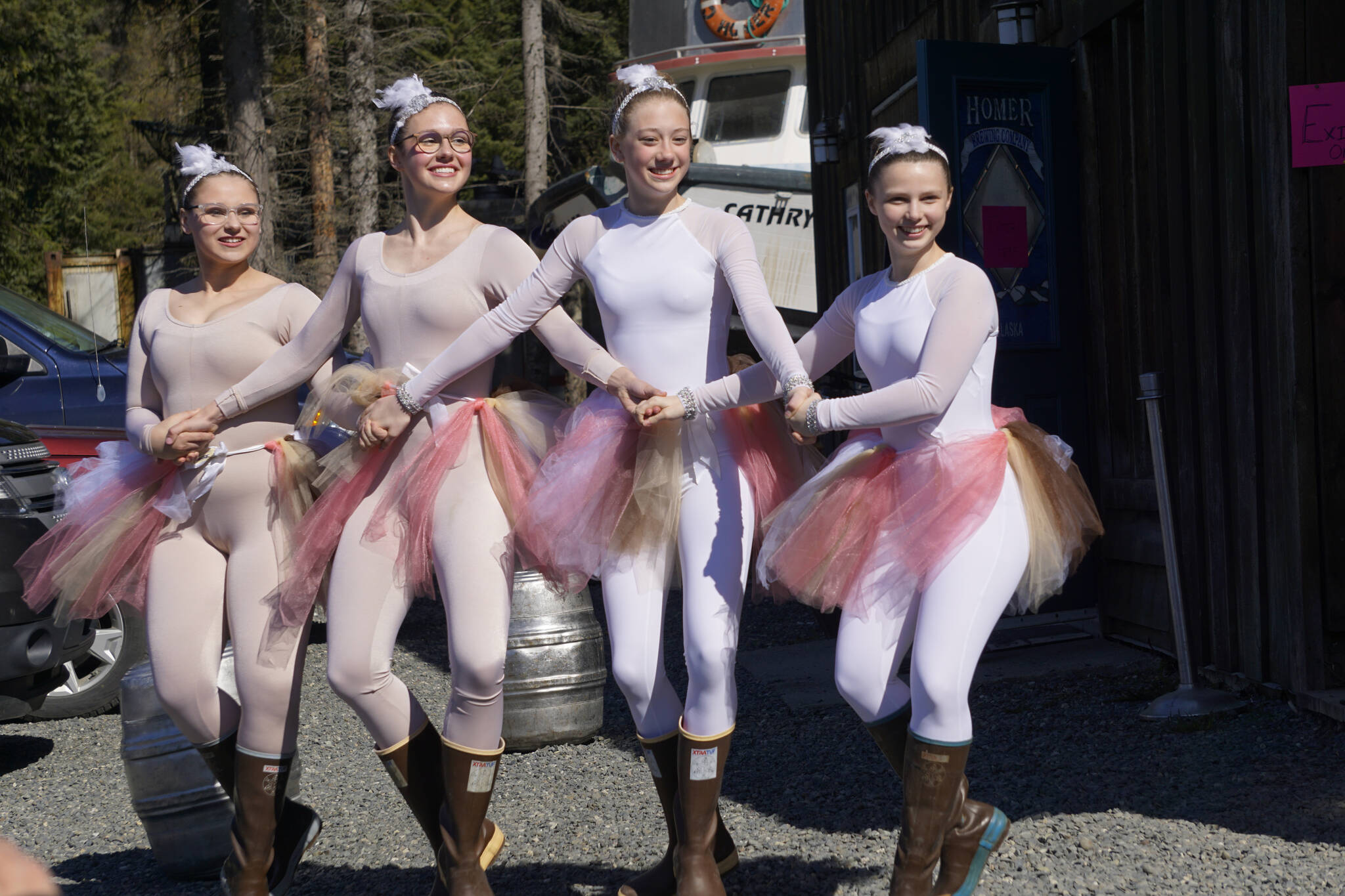 Members of Breezy Berryman’s dance troupe make an appearance for the Homer Brewing Company’s bird calling contest during the Kachemak Bay Shorebird Festival on Saturday, May 7, 2022, in Homer, Alaska. The troupe performed “The Ballet of the Birds” earlier that day and later that evening at the Land’s End Quarterdeck. From left to right are Christina Platter, Ireland Styvar, Reilly-Sue Baker and Natalia Sherwood. (Photo by Michael Armstrong/Homer News)