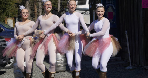 Members of Breezy Berryman's dance troupe make an appearance for the Homer Brewing Company's bird calling contest during the Kachemak Bay Shorebird Festival on Saturday, May 7, 2022, in Homer, Alaska. The troupe performed "The Ballet of the Birds" earlier that day and later that evening at the Land's End Quarterdeck. From left to right are Christina Platter, Ireland Styvar, Reilly-Sue Baker and Natalia  Sherwood. (Photo by Michael Armstrong/Homer News)