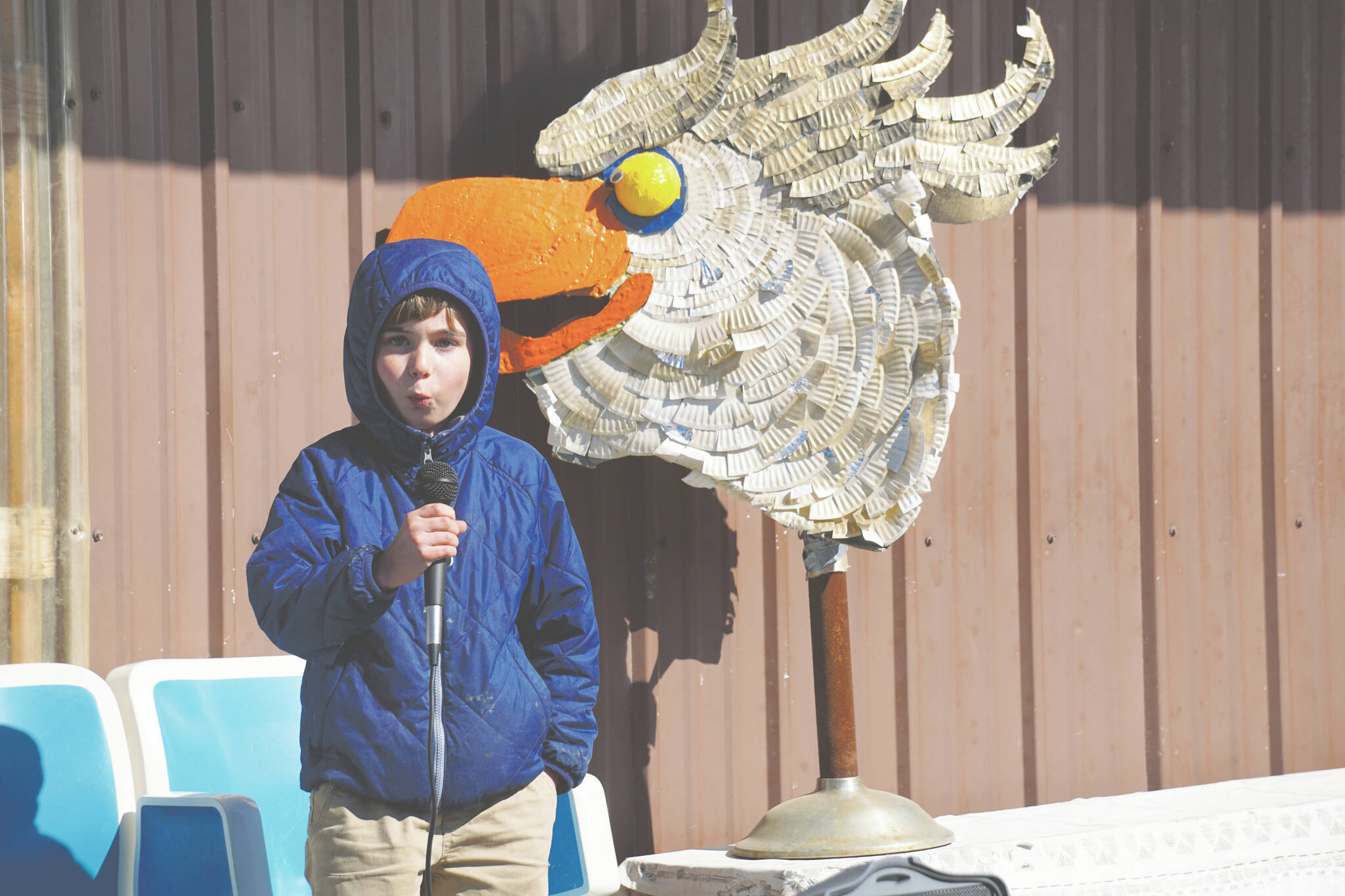 Eli Springer of Fairbanks does his impression of an eagle call for the Homer Brewing Company’s bird calling contest during the Kachemak Bay Shorebird Festival on Saturday, May 7, 2022, in Homer, Alaska. The winner of the serious bird call contest was Cohen McBride of Homer, with his eagle call. (Photo by Michael Armstrong/Homer News)