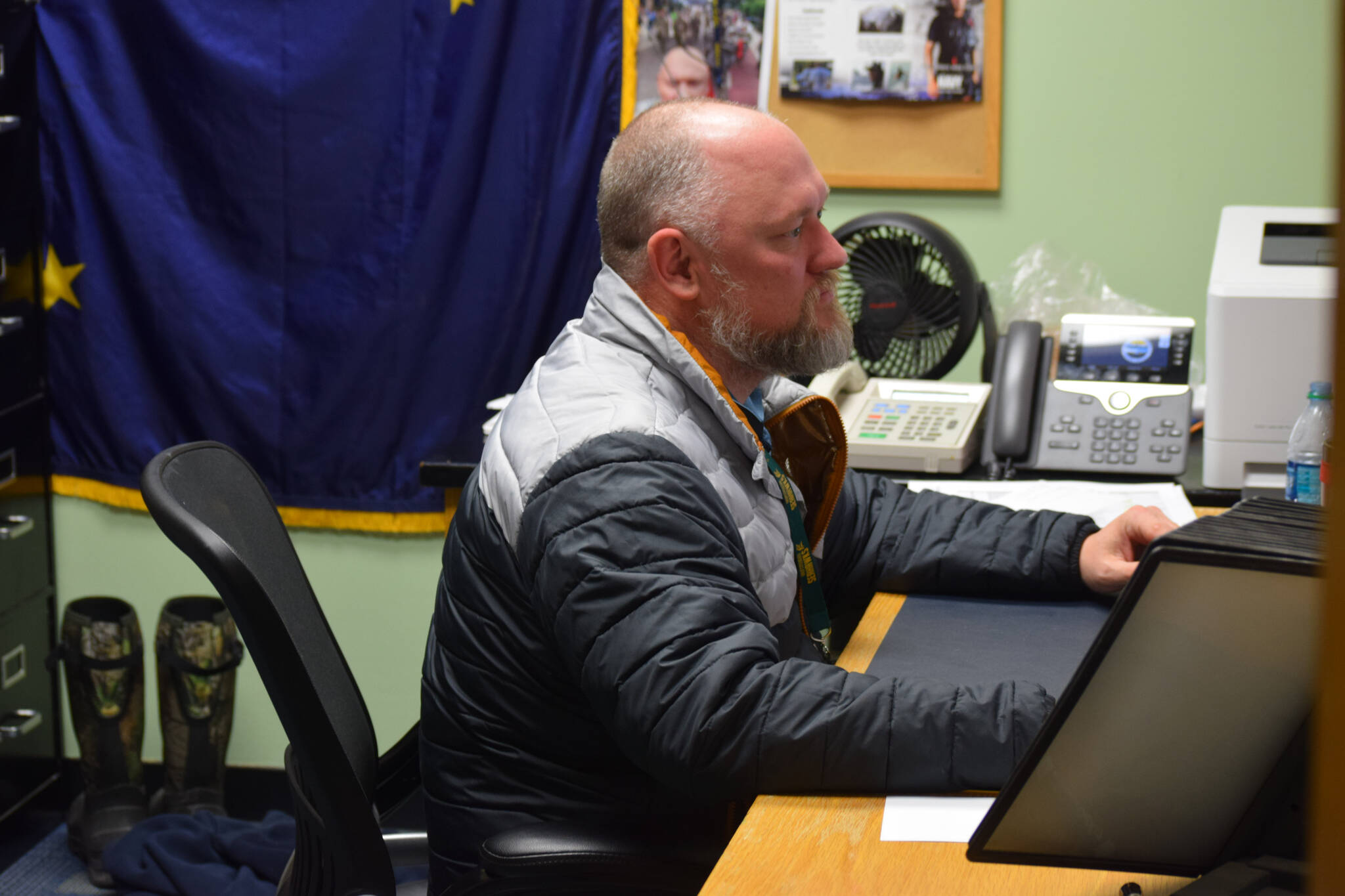 Henry Burns, principal of Seward High School, works in his office in in Seward, Alaska on Tuesday, May 3, 2022. (Camille Botello/Peninsula Clarion)