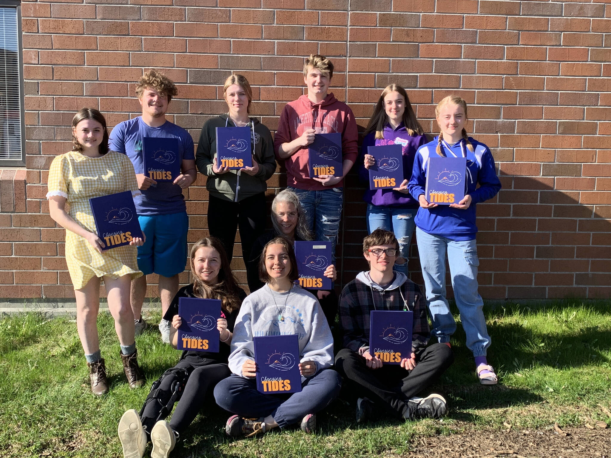 The Homer High School Mariner Logbook staff pose with the 2022 edition at Homer High School in Homer, Alaska. In the back row from left to right are Courtney Rider, Kamdyn Doughty, Bethany Engebretsen, Tyson Walker, Ally High and Charlotte Fraley. In the front row from left to right are Kapitolina Reutov, Mariah McGuire (editor), Suzanne Bishop (advisor) and Damon Weisser. (Photo provided)