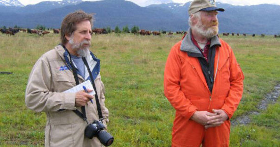 Michael Armstrong, left, wears a flight suit while doing a helicopter tour of agricultural sites in Kachemak Bay in 2008. At right is cattle rancher Chris Rainwater. (Photo provided, U.S. Department of Agrculture)