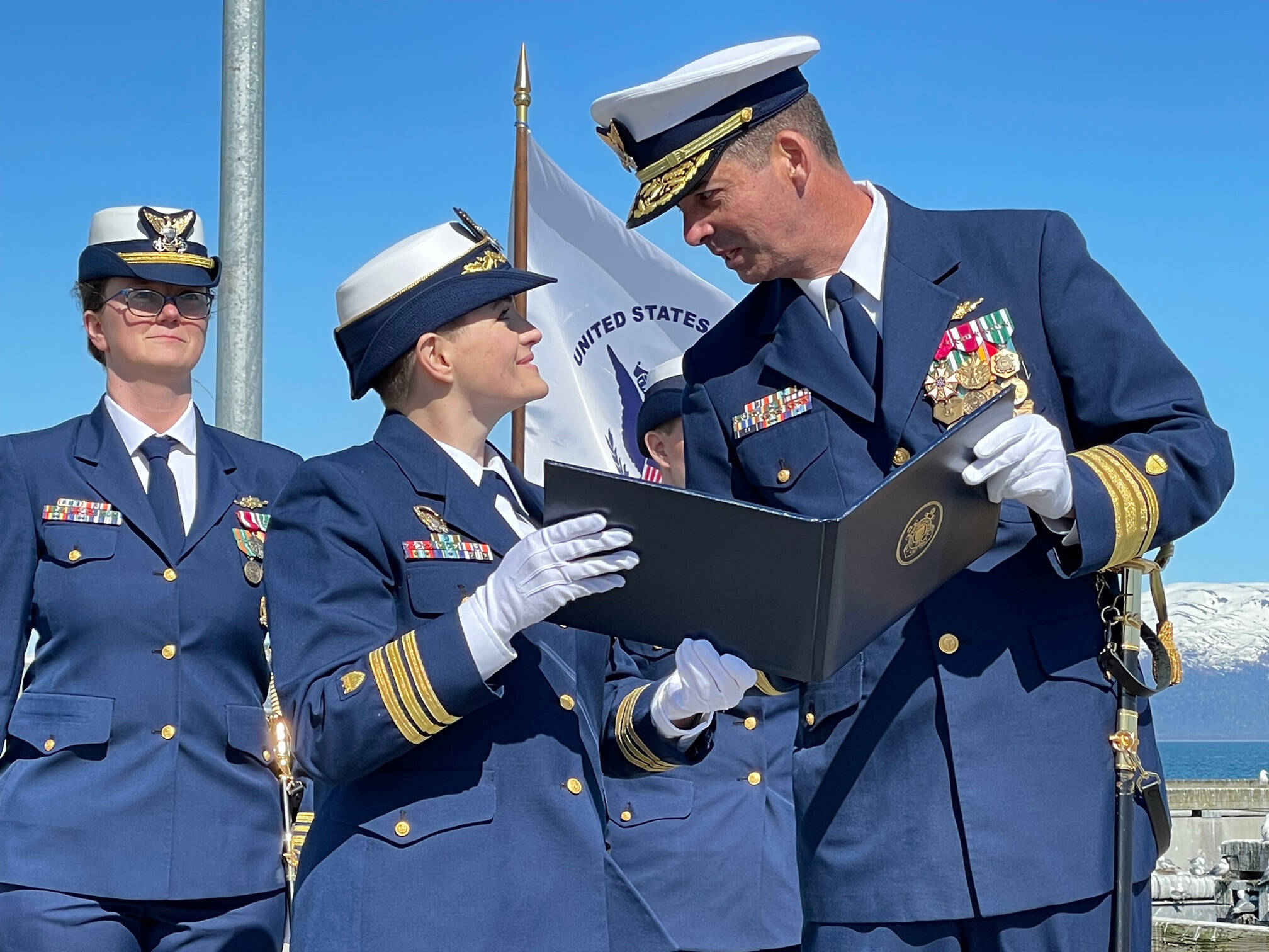 At the May 19, 2022, change of command ceremony in Homer, Alaska, Commander Jeannette Greene, outgoing captain of the USCGC Hickory (left) is presented with the Coast Guard Commendation Medal by Rear Admiral Nathan A. Moore, Seventeenth District Commander, United States Coast Guard. (Photo by McKibben Jackinsky)