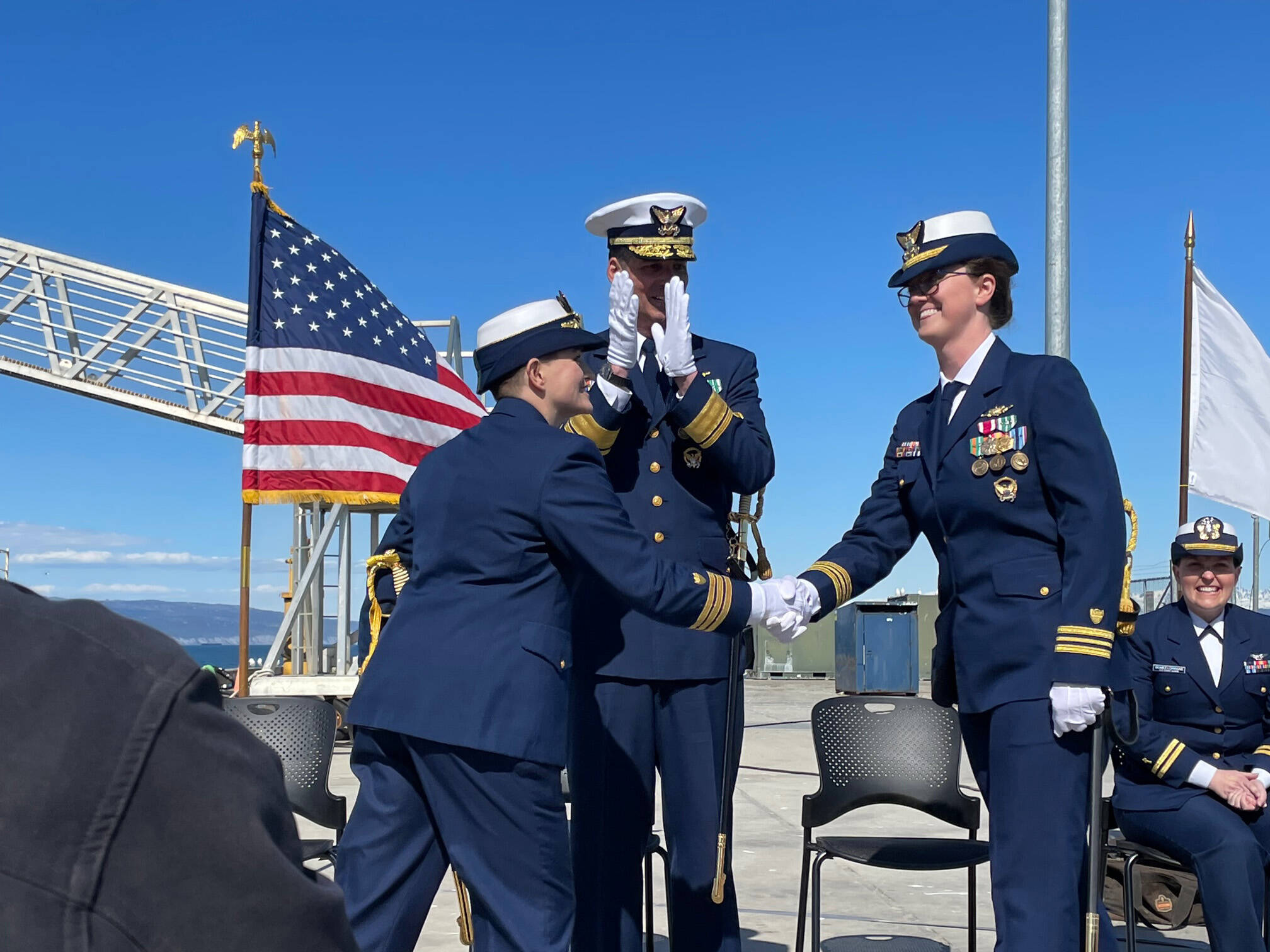 Commander Jeannette Greene, left, turns over command of the USCGC Hickory to Lt. Commander Shea Winterberger at the May 19, 2022, change of command ceremony in Homer, Alaska. (Photo by McKibben Jackinsky)