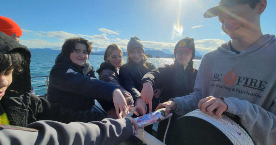 Members of Homer Flex School's Marine Biology class on April 21, 2022, prepare to deploy a CTD, or conductivity, temperature, and depth, device in Kachemak Bay, Alaska. (Photo provided, Center for Alaskan Coastal Studies)