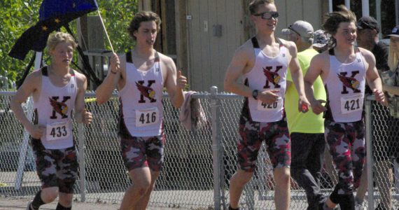 Kenai Central’s James Sparks, Jacob Begich, Tyler Hippchen and Reagan Graves celebrate after winning the boys Division II 400-meter relay Saturday, May 28, 2022, at the Division II state track and field meet at Dimond High School in Anchorage, Alaska. (Photo by Jeff Helminiak/Peninsula Clarion)