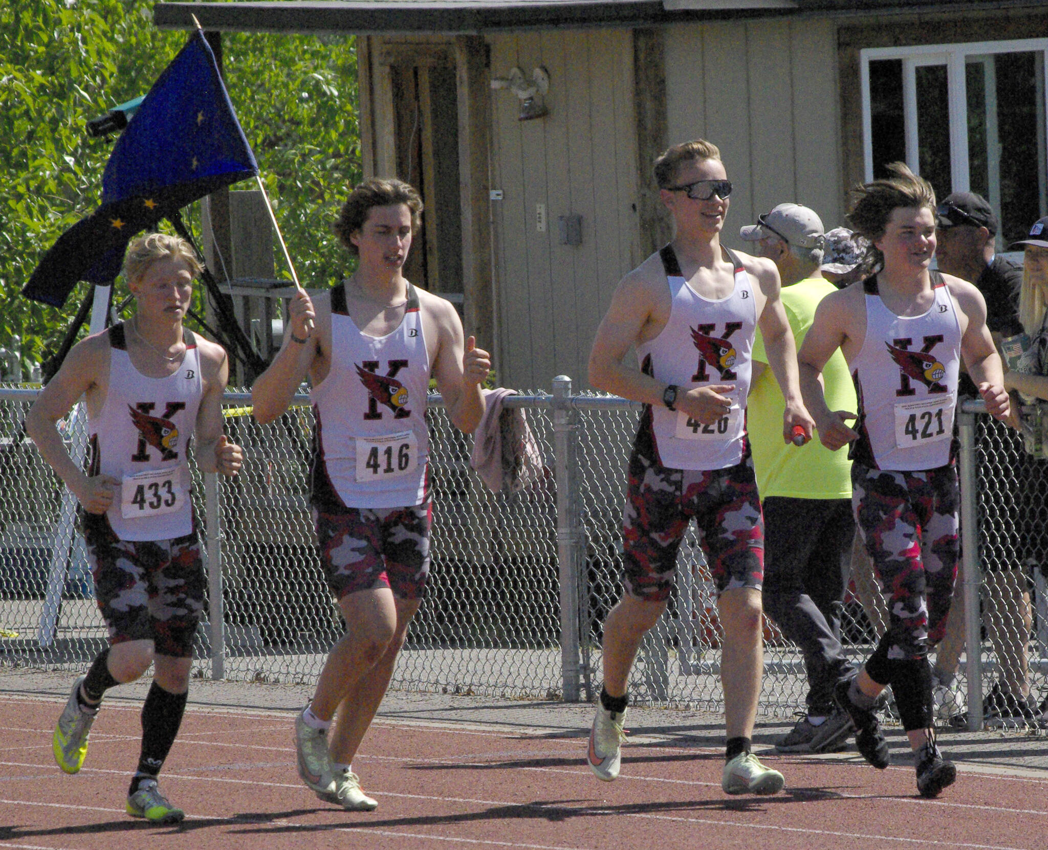 Kenai Central’s James Sparks, Jacob Begich, Tyler Hippchen and Reagan Graves celebrate after winning the 400-meter relay Saturday, May 28, 2022, at the Division II state track and field meet at Dimond High School in Anchorage, Alaska. (Photo by Jeff Helminiak/Peninsula Clarion)