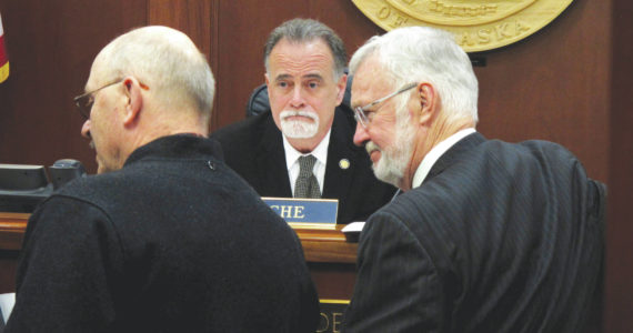 Alaska state Senate President Peter Micciche, center, looks on as Sen. Gary Stevens, R- Kodiak, and oher lawmakers gather in front of him on the Senate floor on Wednesday, May 4, in Juneau. (AP Photo/Becky Bohrer)
Alaska state Senate President Peter Micciche, center, looks on as lawmakers gather in front of him on the Senate floor on Wednesday, May 4, 2022, in Juneau, Alaska. A bill dealing with the annual dividend paid to residents was bumped from the Senate floor on Wednesday. Micciche said it did not have the votes to pass. (AP Photo/Becky Bohrer)