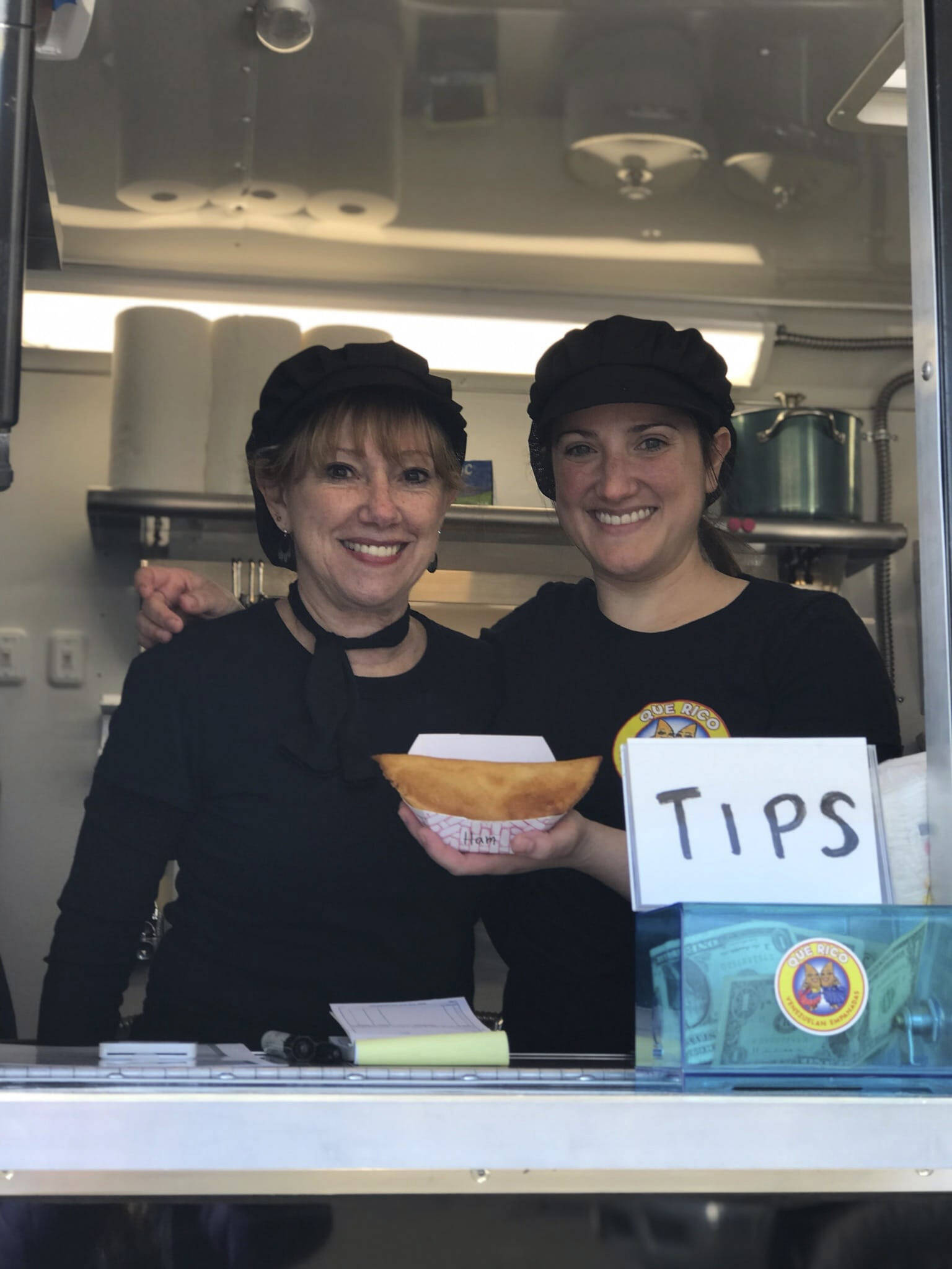 Jeannette Aragones, left, and her daughter, Jessica Hahn, right, pose in their new food truck, Que Rico. (Photo provided)